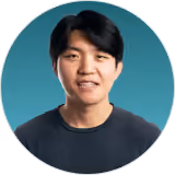 Headshot of a smiling young DualEntry team member in a dark tee