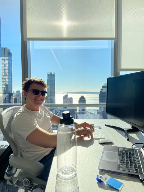DualEntry team member working at a desk overlooking the New York skyline