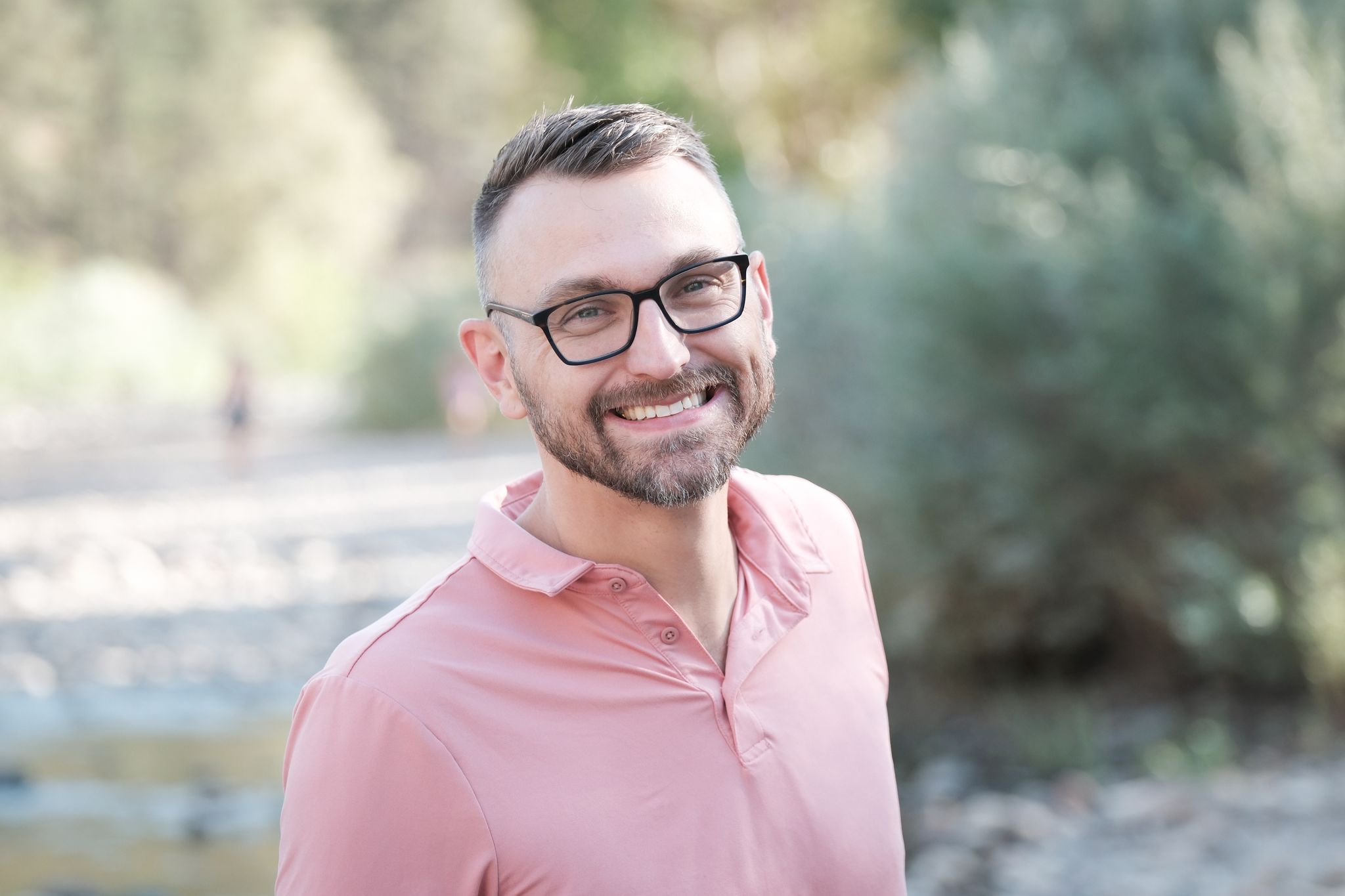 A man smiles into the camera