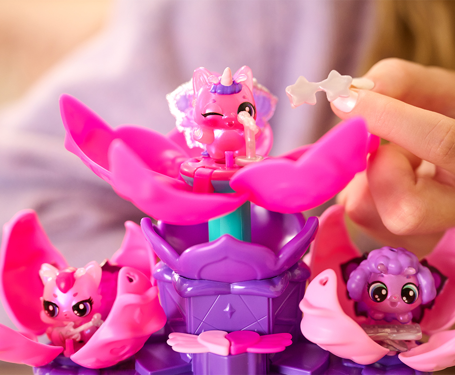 Three Bloomables figurines sit on the opened flower petal platforms of the Flower Fest toy