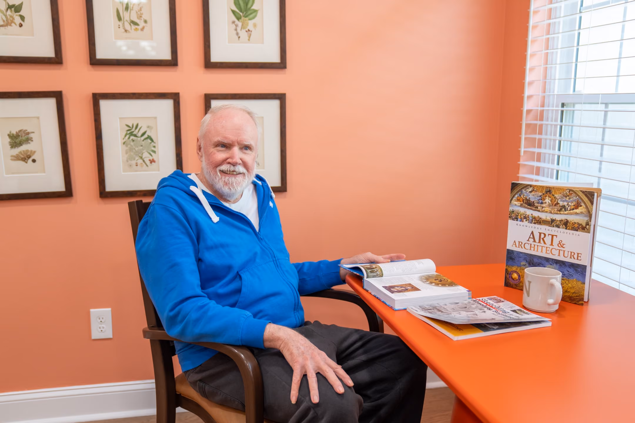 A resident engaged in sketching and art at St. Ives Hometown Living of Johns Creek, illustrating person-centered dementia care within a small memory care community focused on familiarity and comfort.