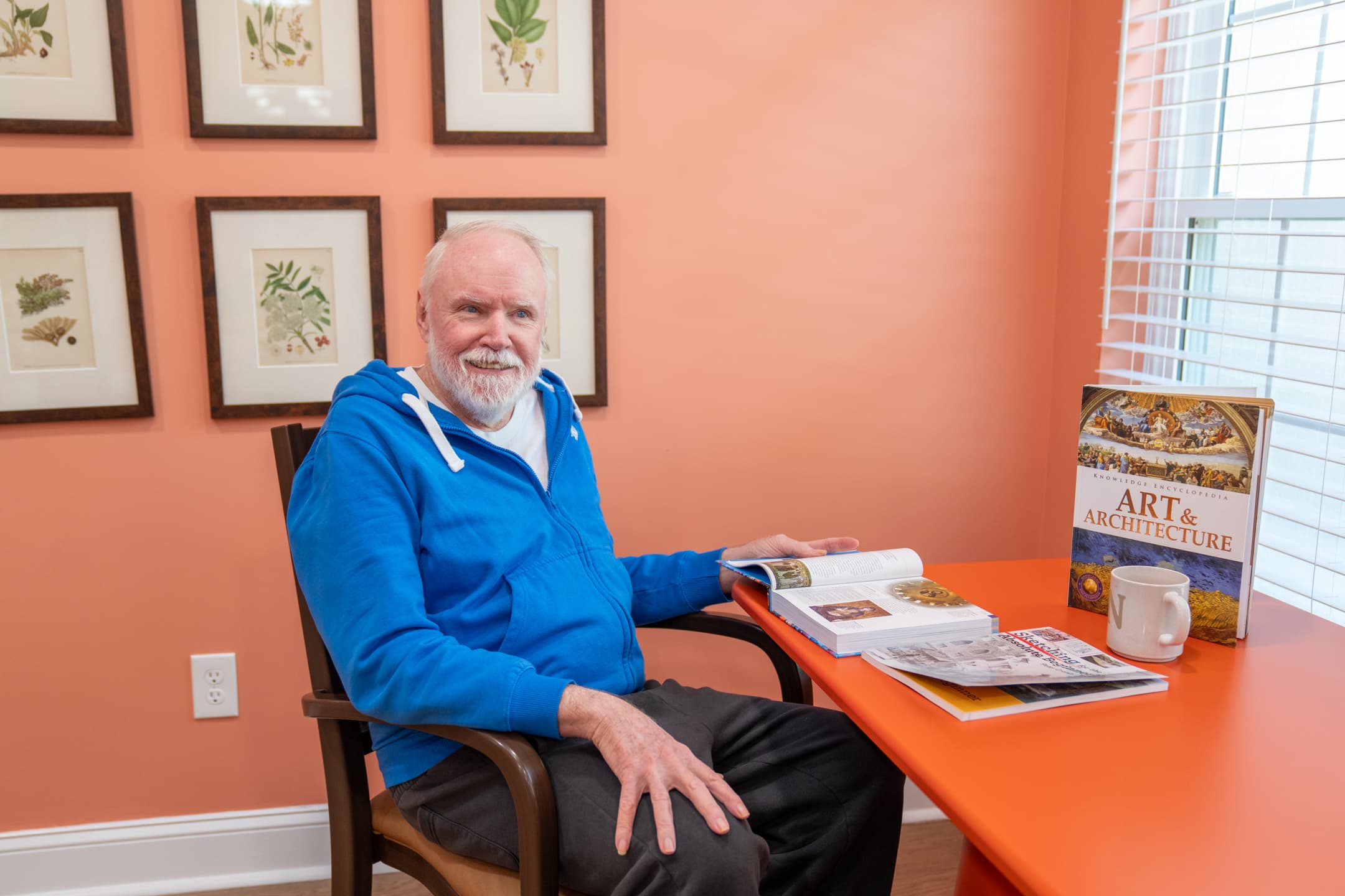 A resident engaged in sketching and art at St. Ives Hometown Living of Johns Creek, illustrating person-centered dementia care within a small memory care community focused on familiarity and comfort.