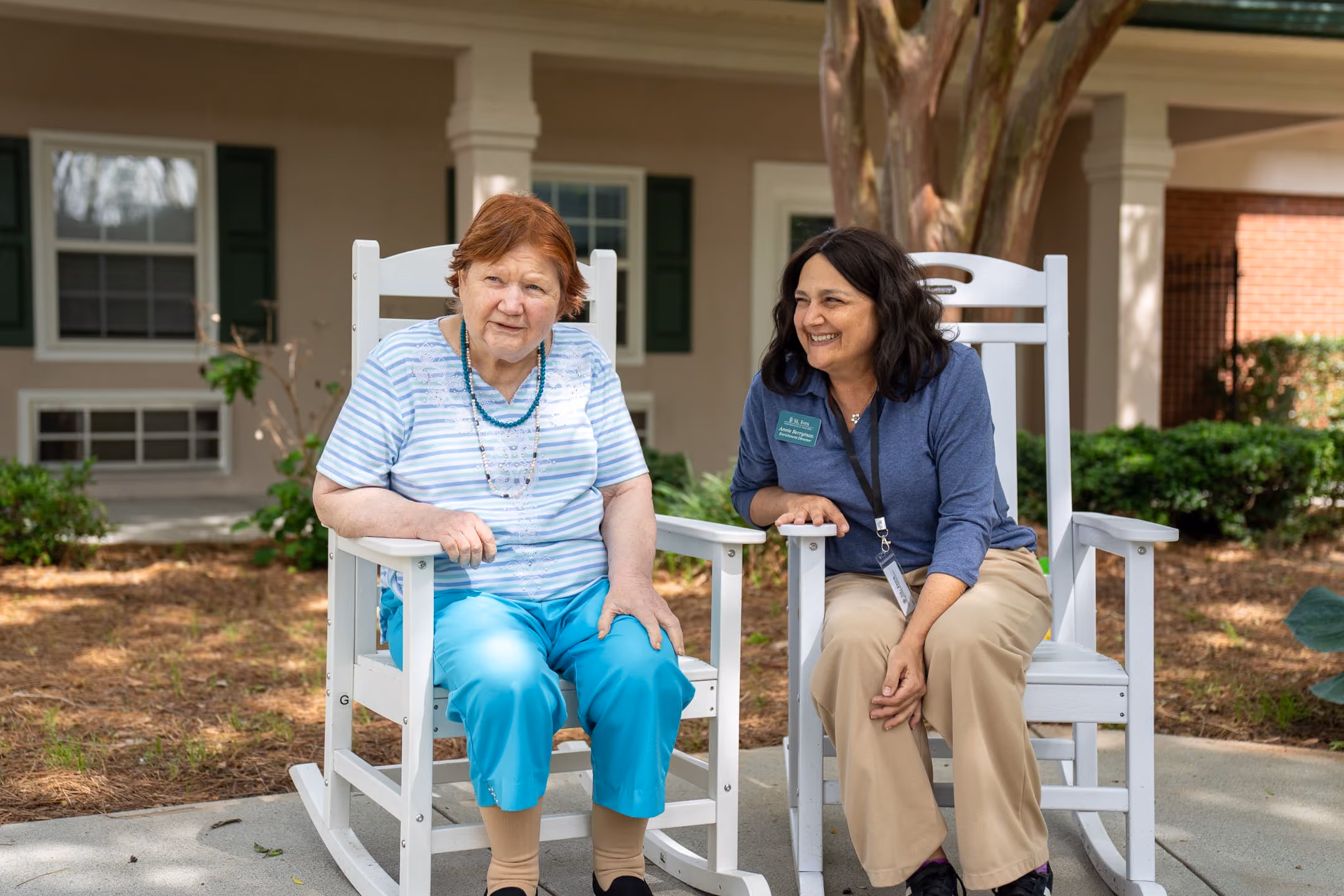 A resident spending time with a team member at St. Ives Hometown Living of Johns Creek, highlighting the support and familiar relationships that can help when learning how to transition a parent to memory care.