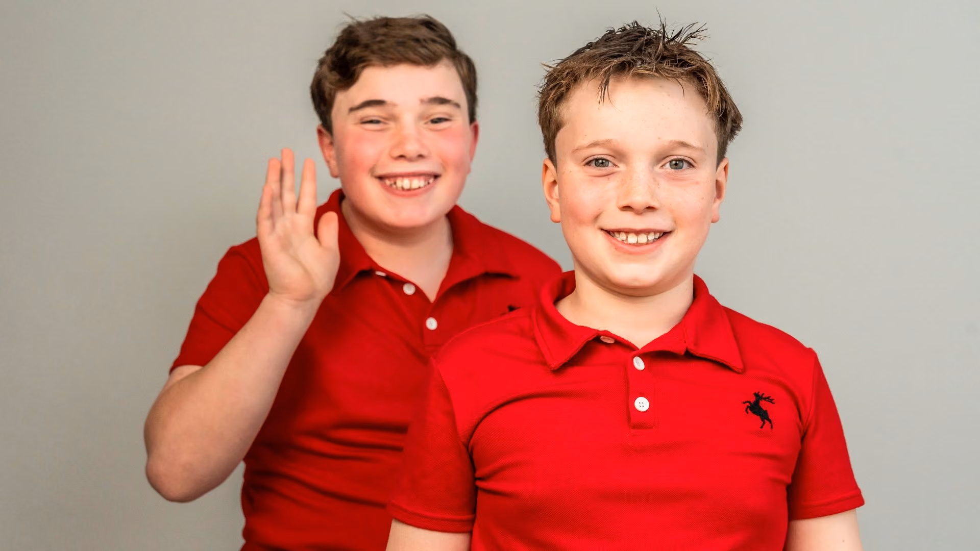 Two young children smiling at camera