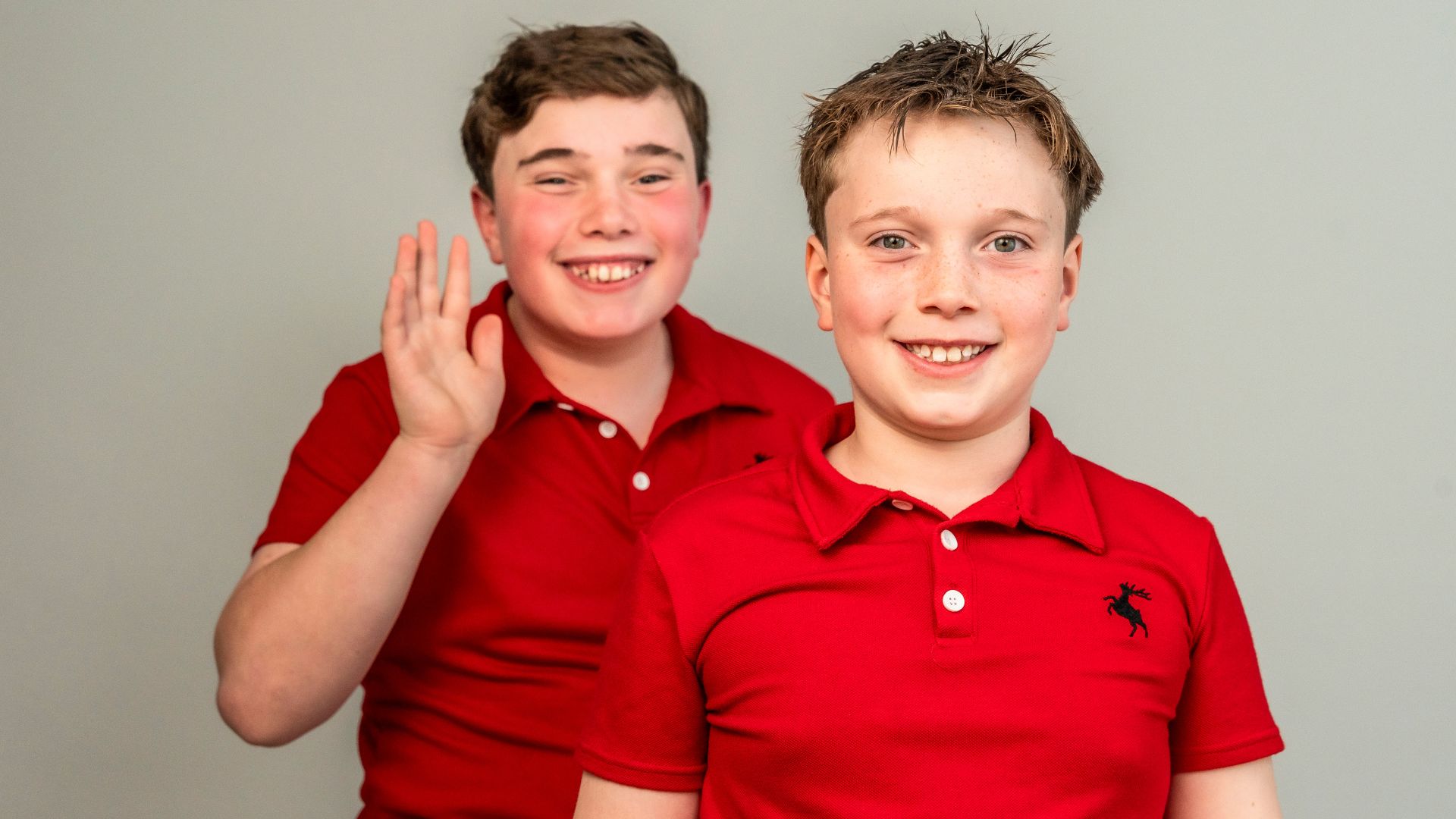 Two young children smiling at camera