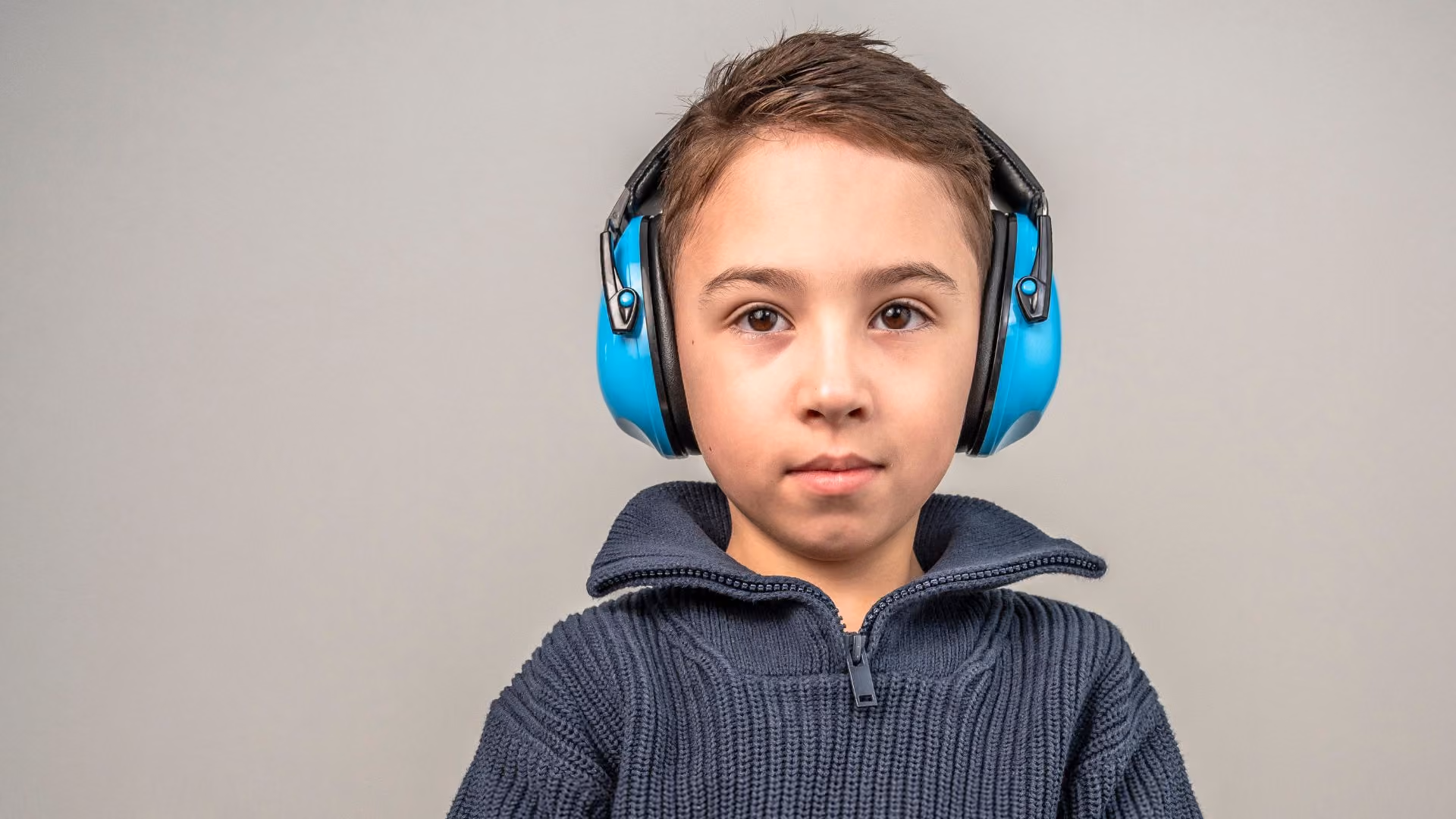 young autistic by wearing ear defenders