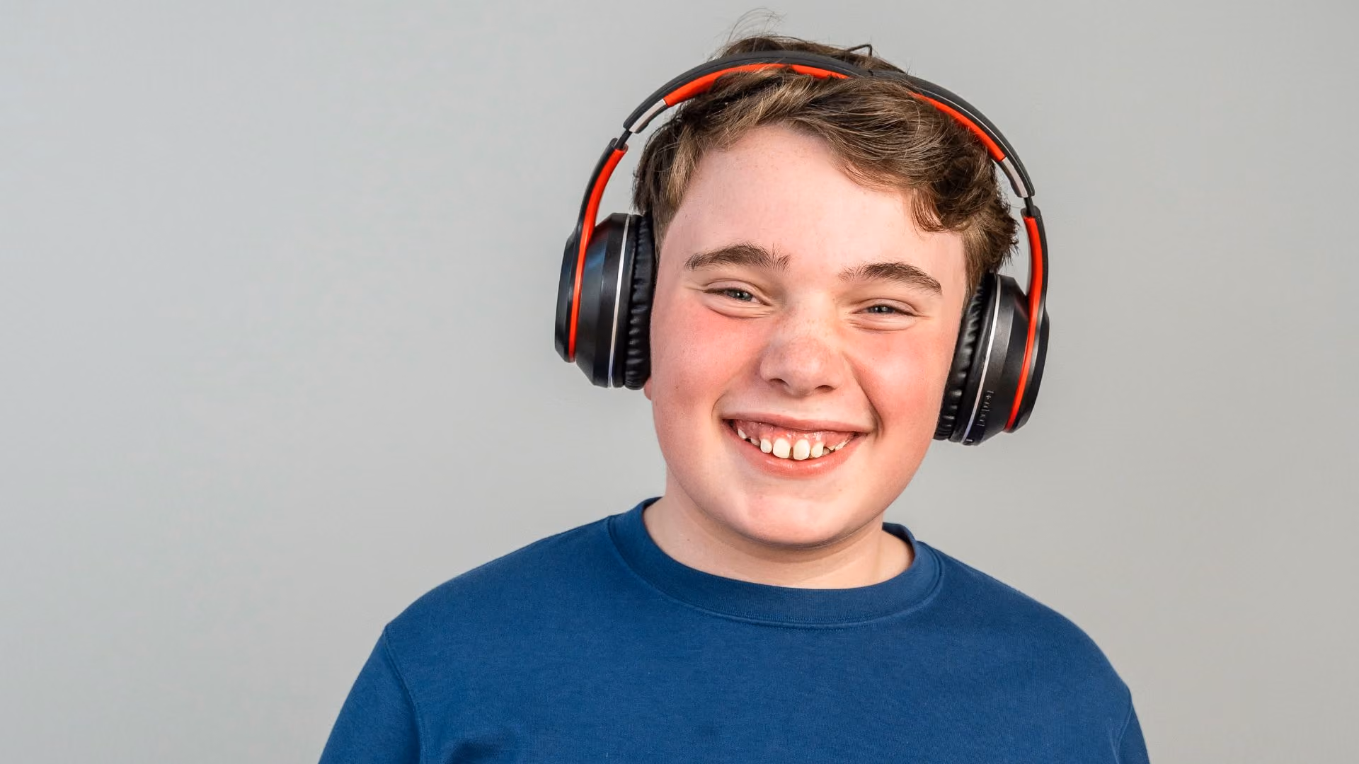 autistic boy wearing ear defenders