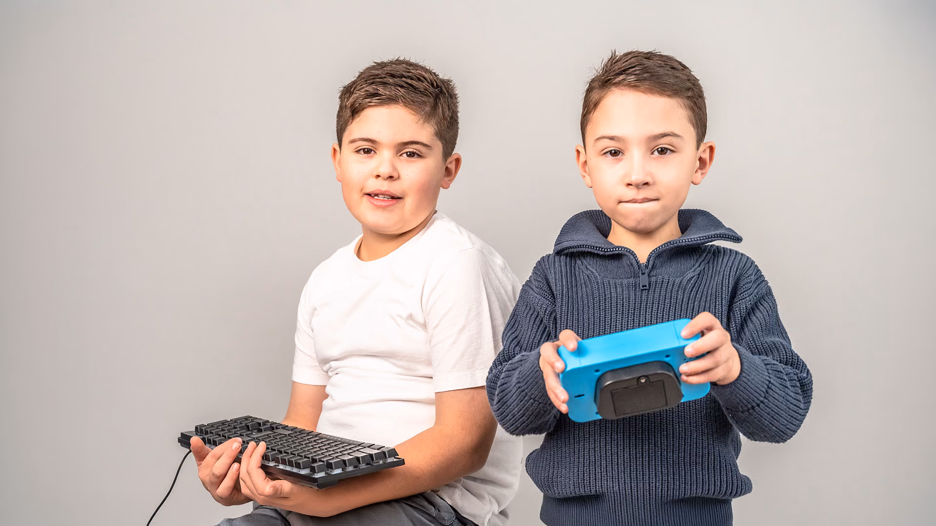 Two autistic boys playing with tech