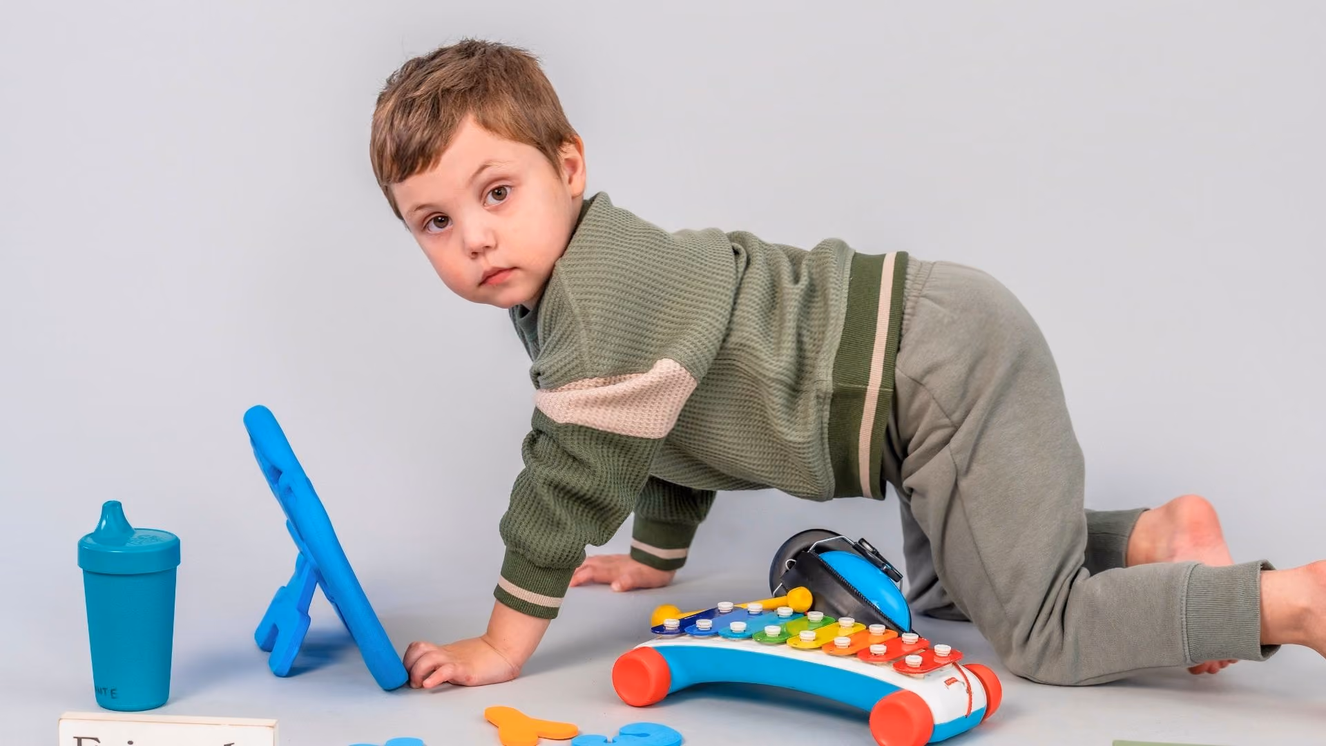 young autistic boy playing with toys