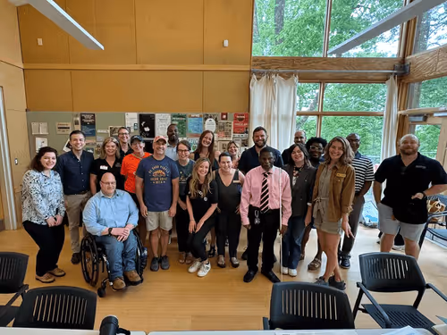 A group of people in the Ruffner Mountain Nature Center posing for a photo after a meeting about East Side Park