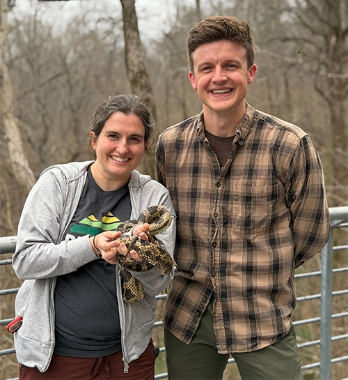 Jefferson County Greenways Naturalists Emily Hutto and Hunter Meadows with Grady, a Gray/Central Ratsnake, Pantherophis alleghaniensis, and one of the Wildlife Ambassadors at the Nature Center.