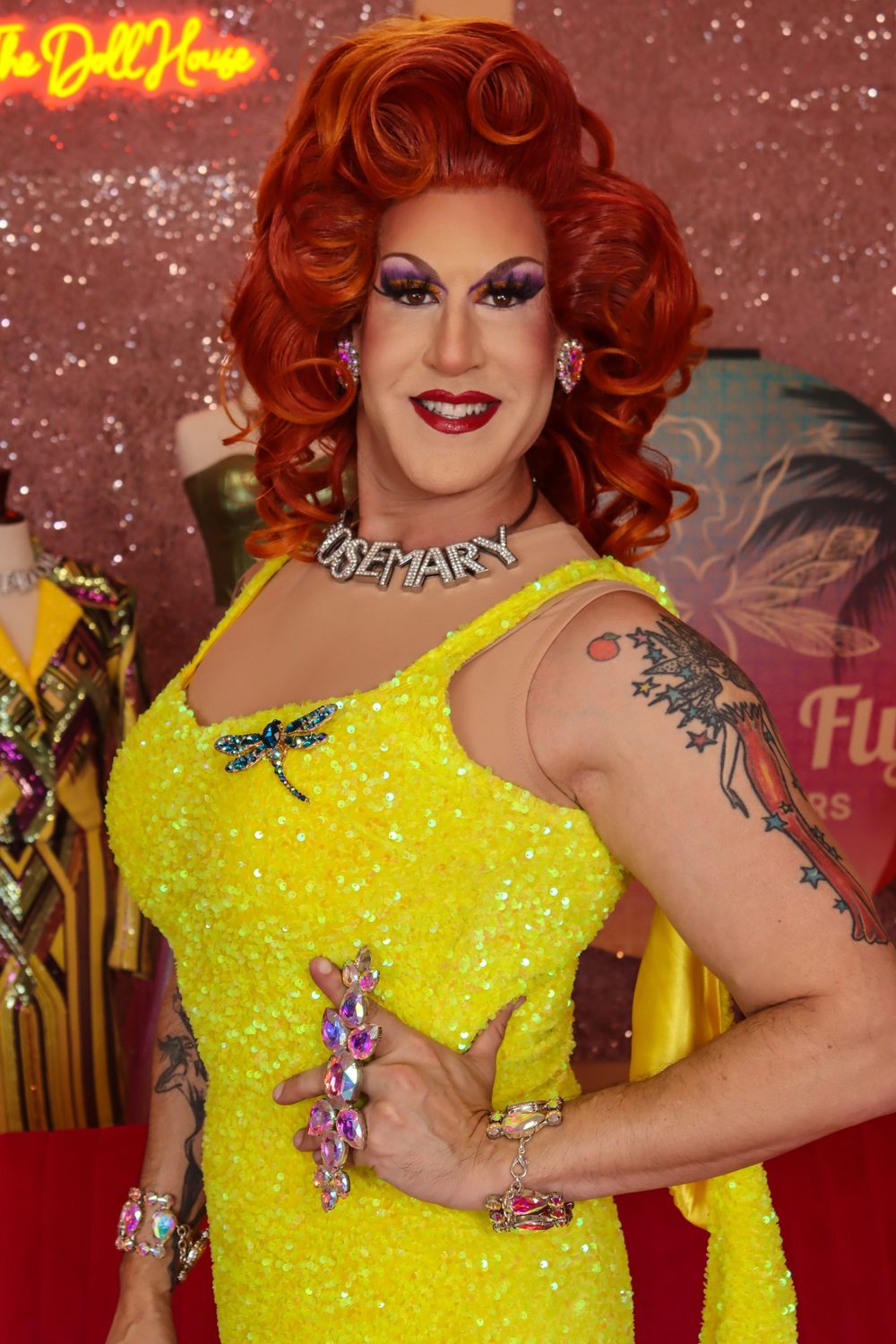 Rosemary Galore, drag queen tour guide for Drag & Fly Tours, in a yellow sequin gown at The Doll House in Palm Springs