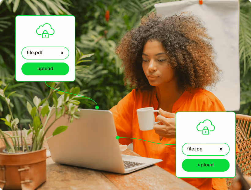 Woman in orange shirt sitting at a wooden table using a laptop and holding a white mug, with digital upload icons for file.pdf and file.jpg displayed near the laptop.
