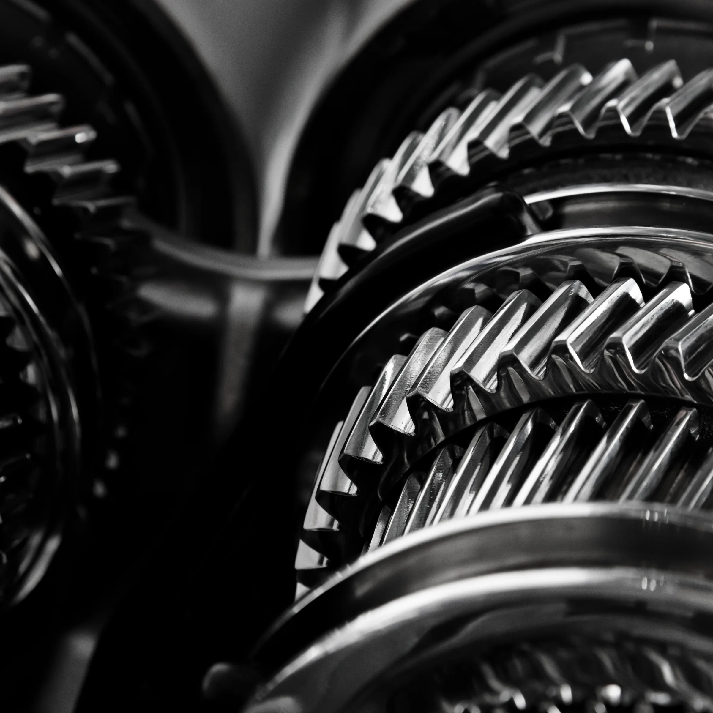 Close-up of interlocking shiny metal gears in a mechanical system.