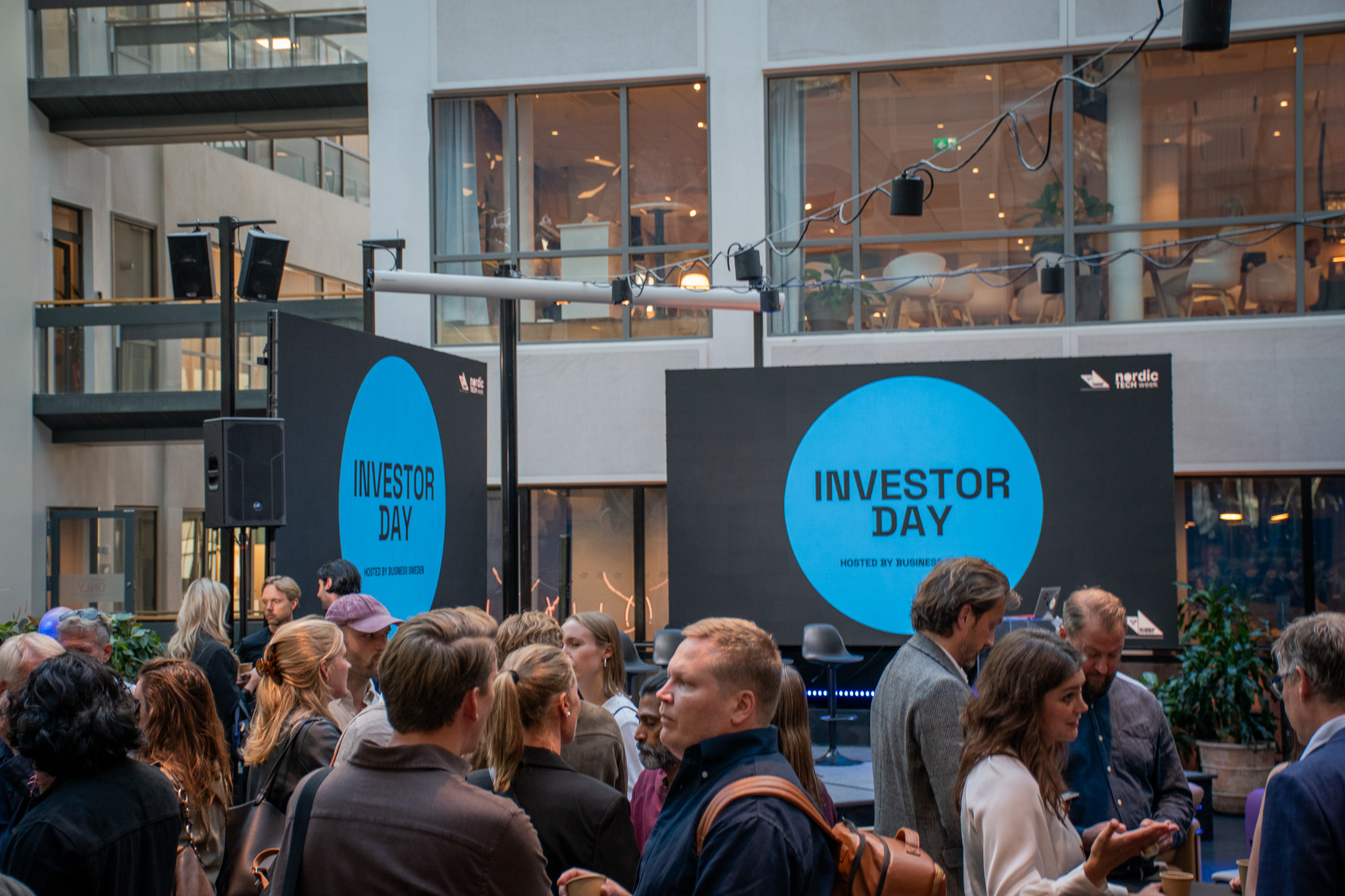 Mingel framför LED-skärmar under ett företagsevent på Epicenter Stockholm