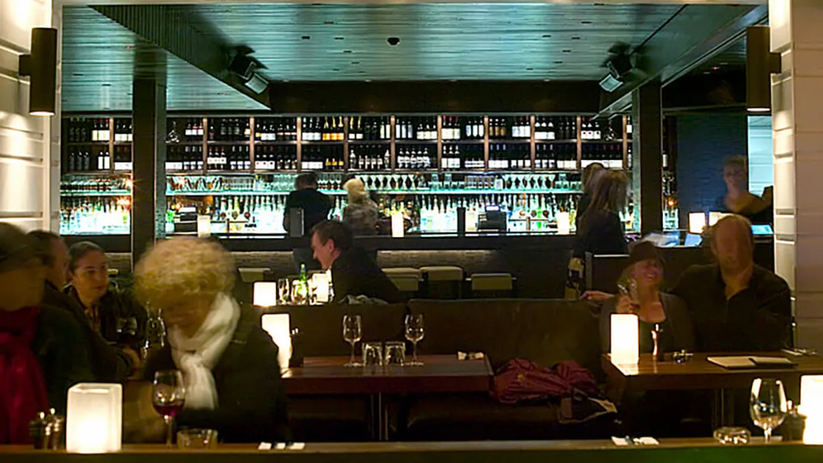 a group of people sitting at a bar