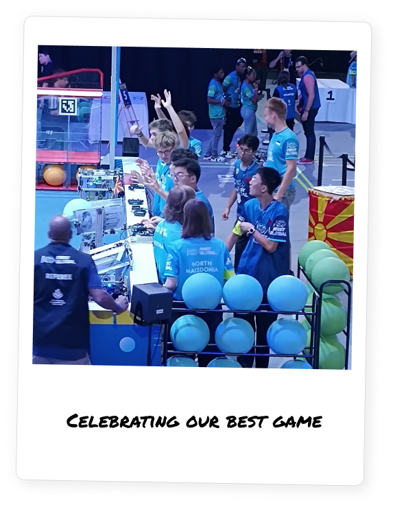 Polaroid photo of Team North Macedonia celebrating their best match at the FIRST Global Challenge 2024, under the mentorship of Jakov Spirovski. The team, dressed in blue shirts, is shown near their robot in a moment of shared success, with the Macedonian flag in the background—highlighting collaboration, strategy, and national pride.