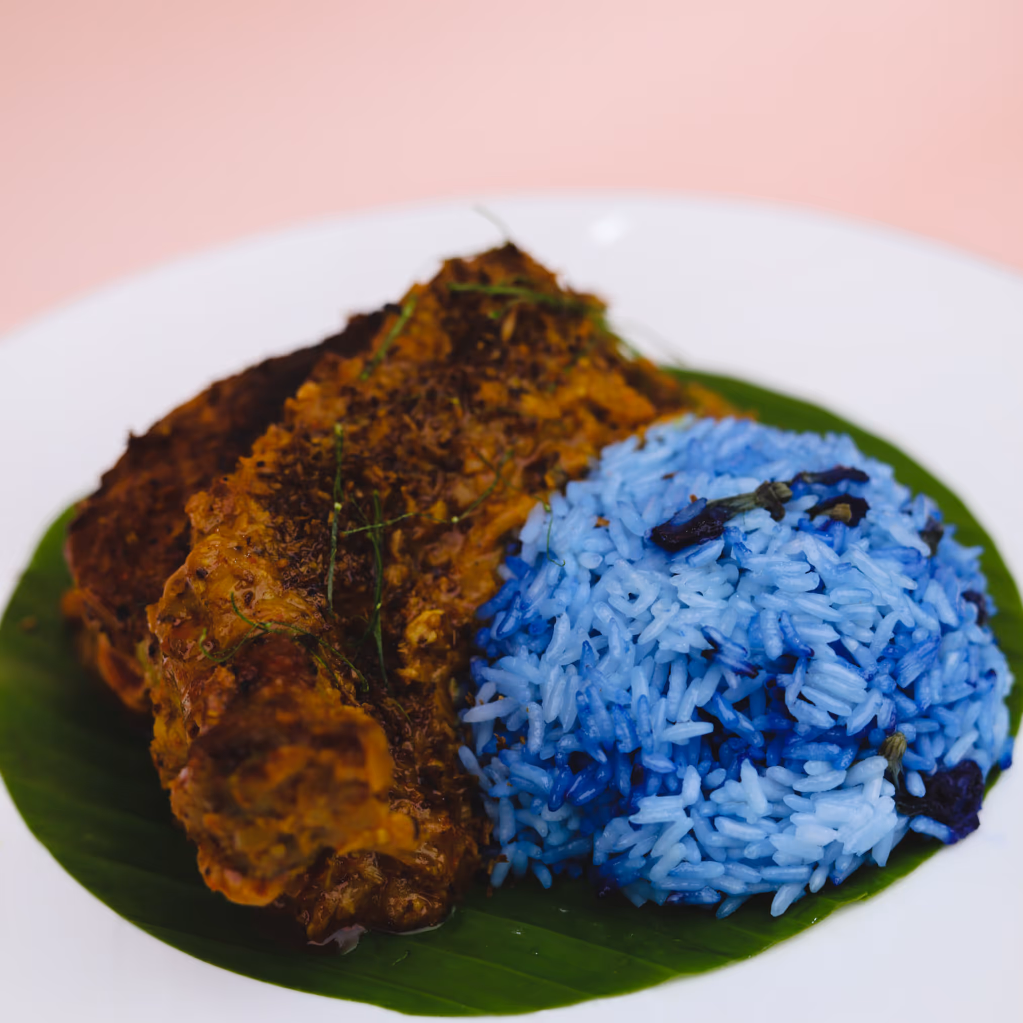 peranakan dish of meat and blue pea rice
