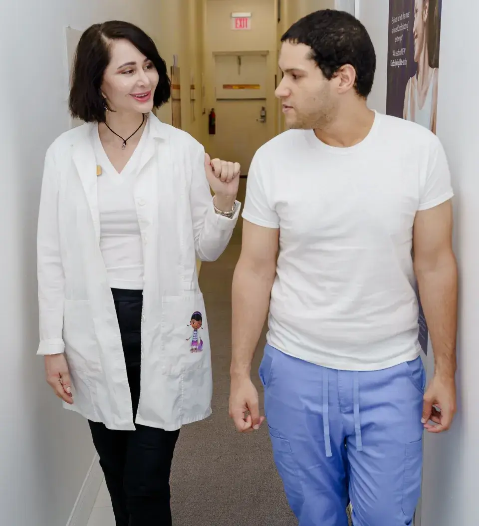 a man and a woman walking down a hallway
