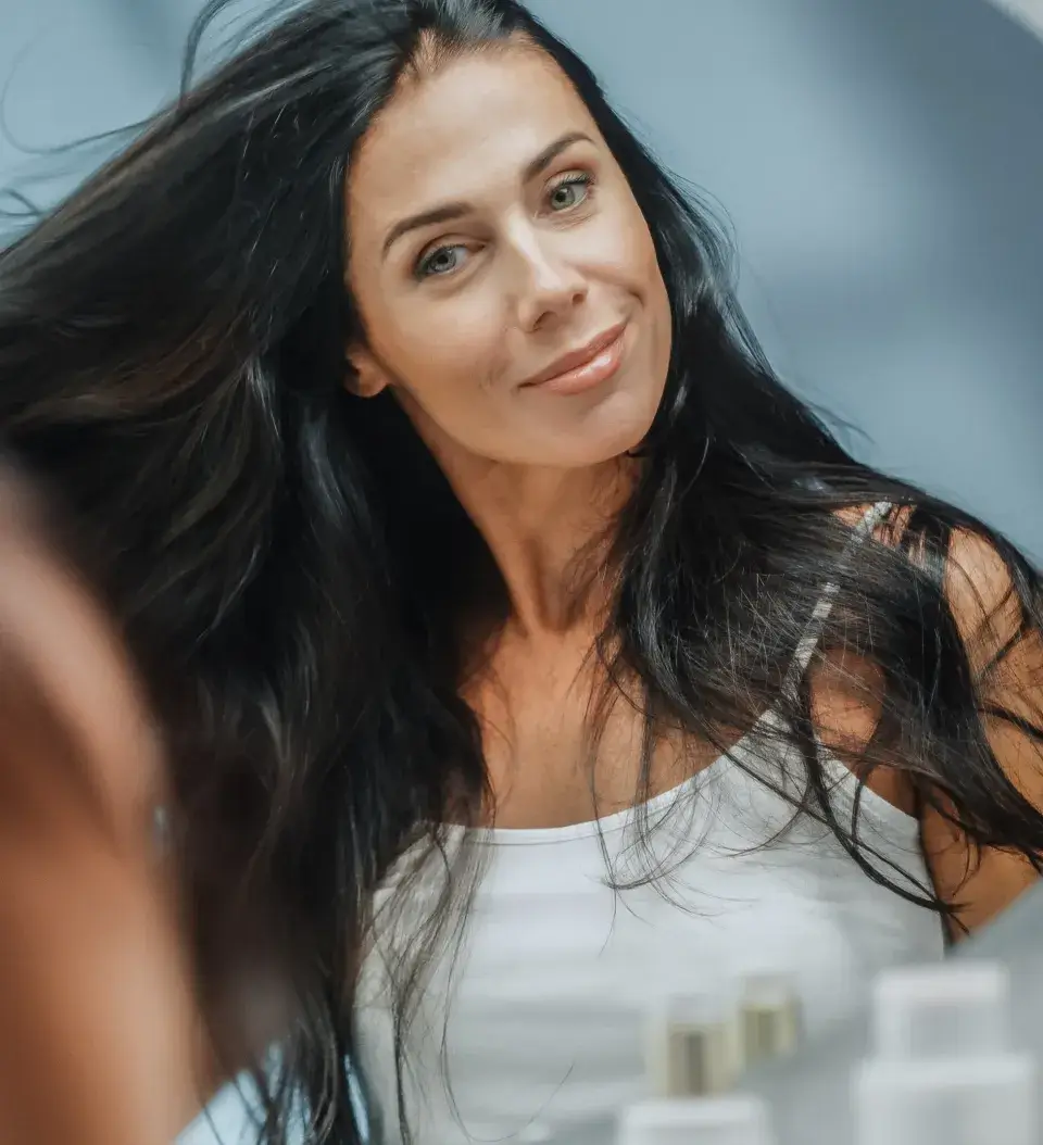 a close up of a woman brushing her hair