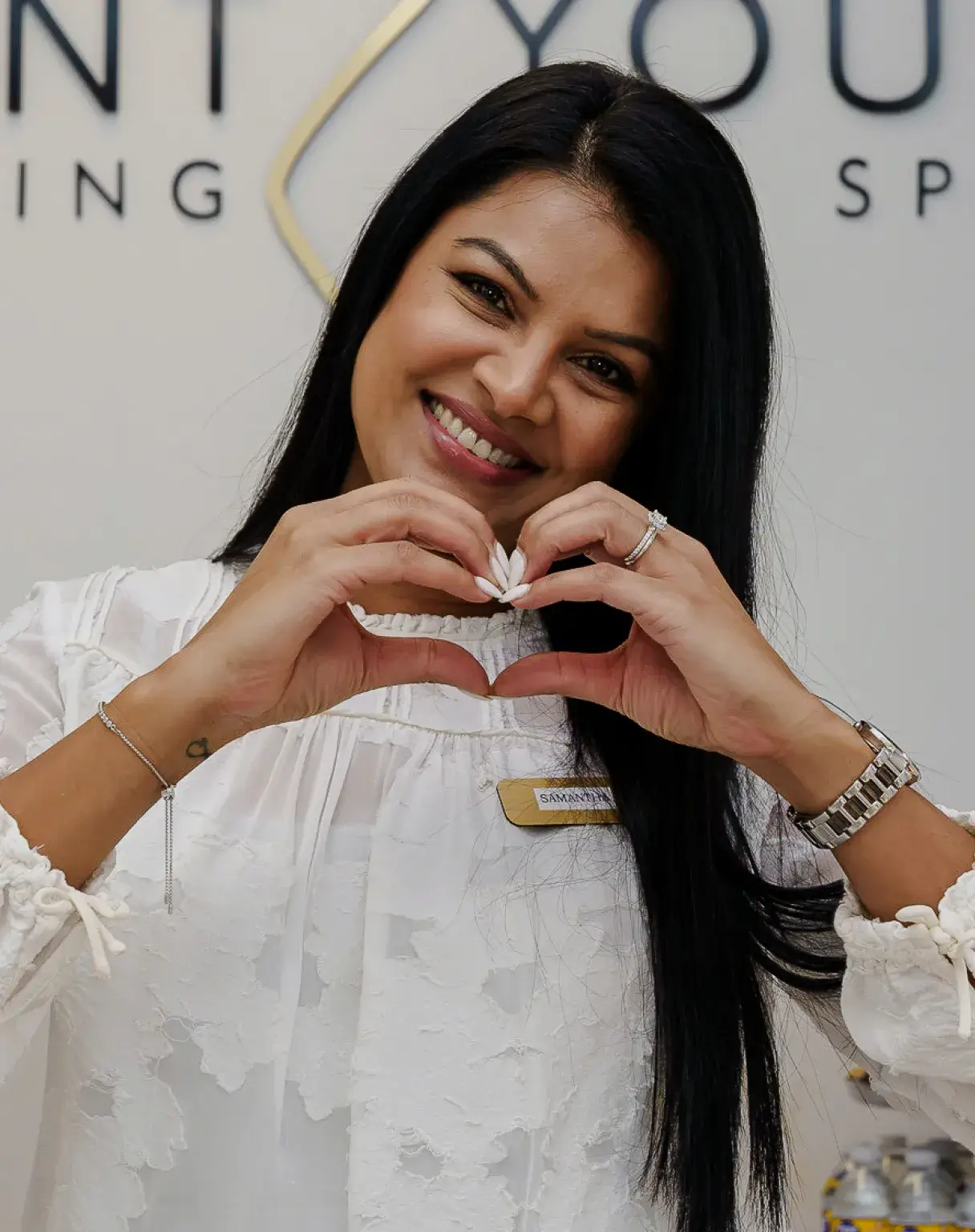 a woman making a heart with her hands