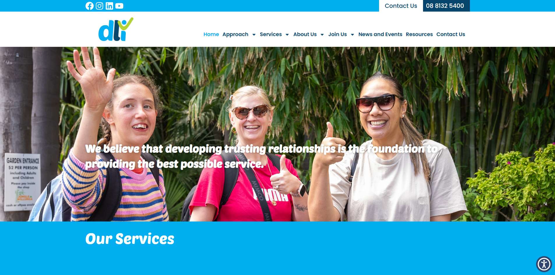 Three women smiling and giving thumbs up at a community event supported by DLi – a not-for-profit focused on building inclusive, trusting relationships in Australia.