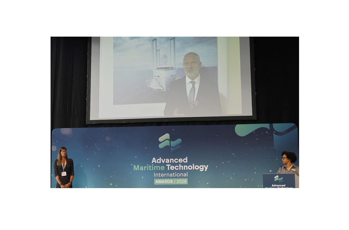 The stage of Advanced Maritime Technology International Awards 2026. On the screen, Emmanuel Schalit, CEO of OceanWings, is displayed with a picture of canopée vessel equipped with wingsails from OceanWings.
