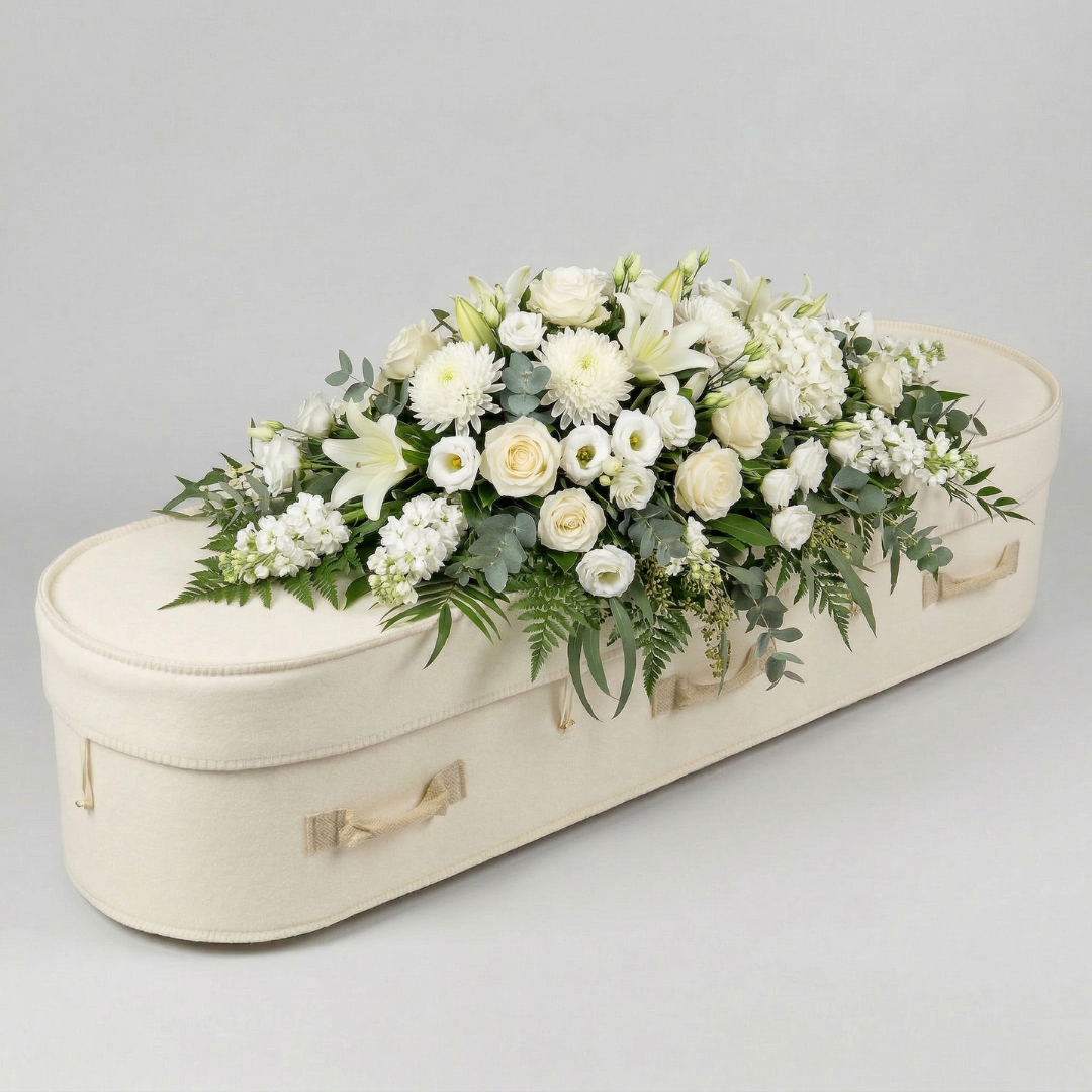 Premium full funeral coffin spray cascading over sides — from $1150