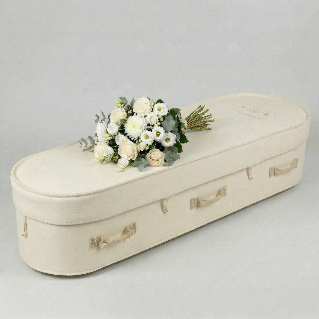 Essential hand-tied funeral flower sheaf on coffin — from $550