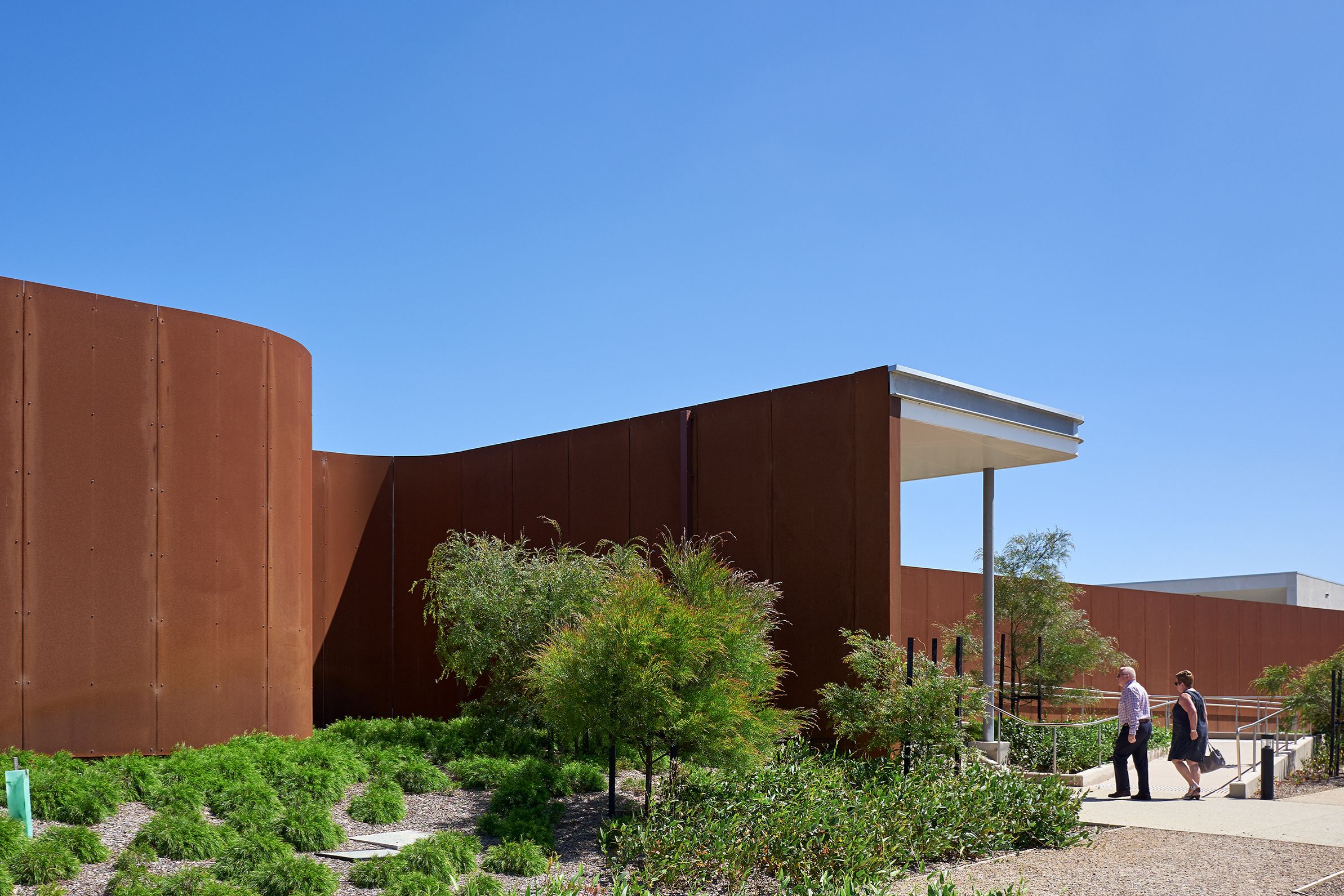 Weathered Corten steel wall and native garden at Bunurong Memorial Park