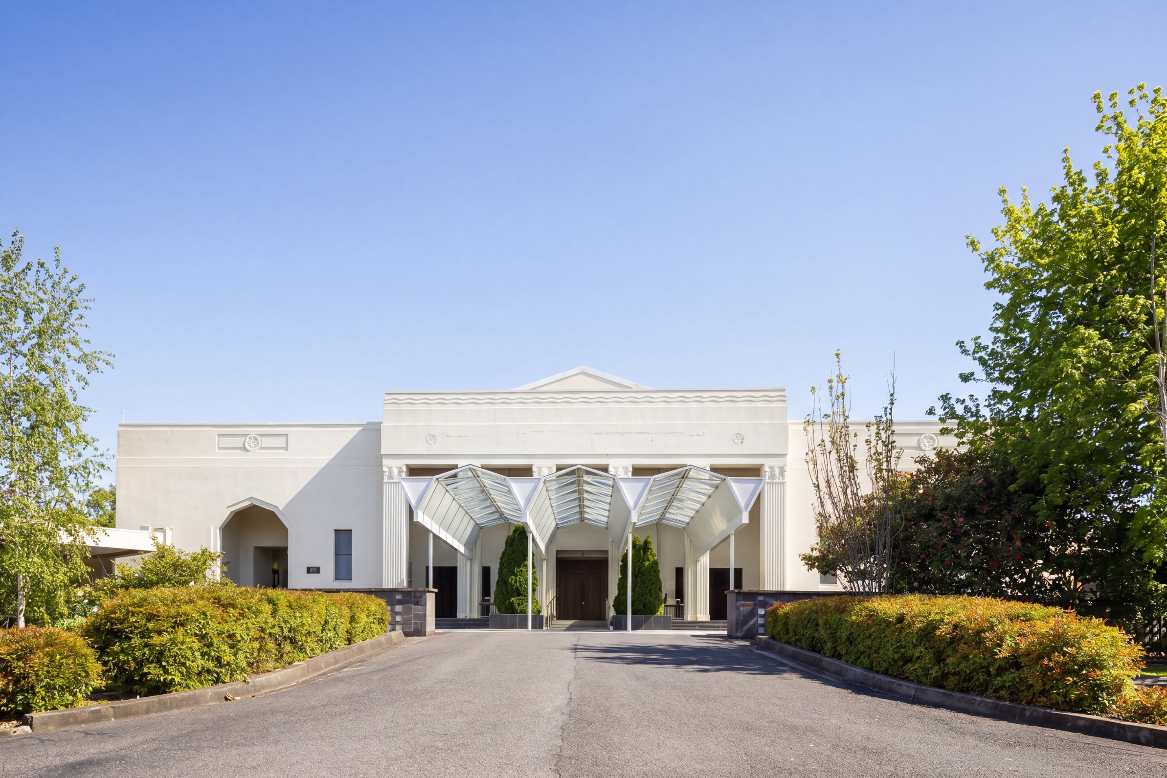 The 1930s chapel building and its glass entrance canopy at Springvale Botanical Cemetery