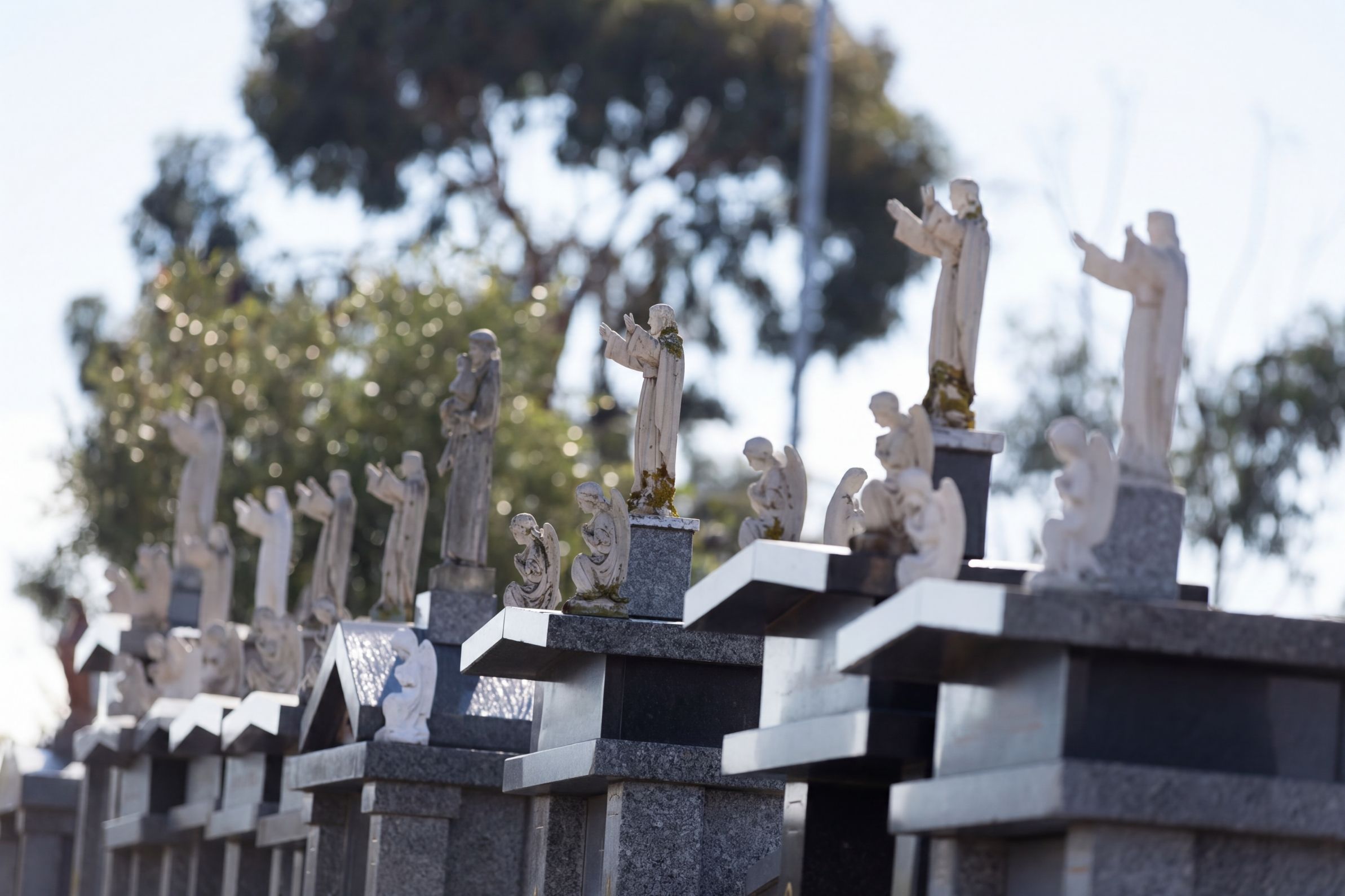 Guardian statues standing over the graves at Preston Cemetery, Bundoora