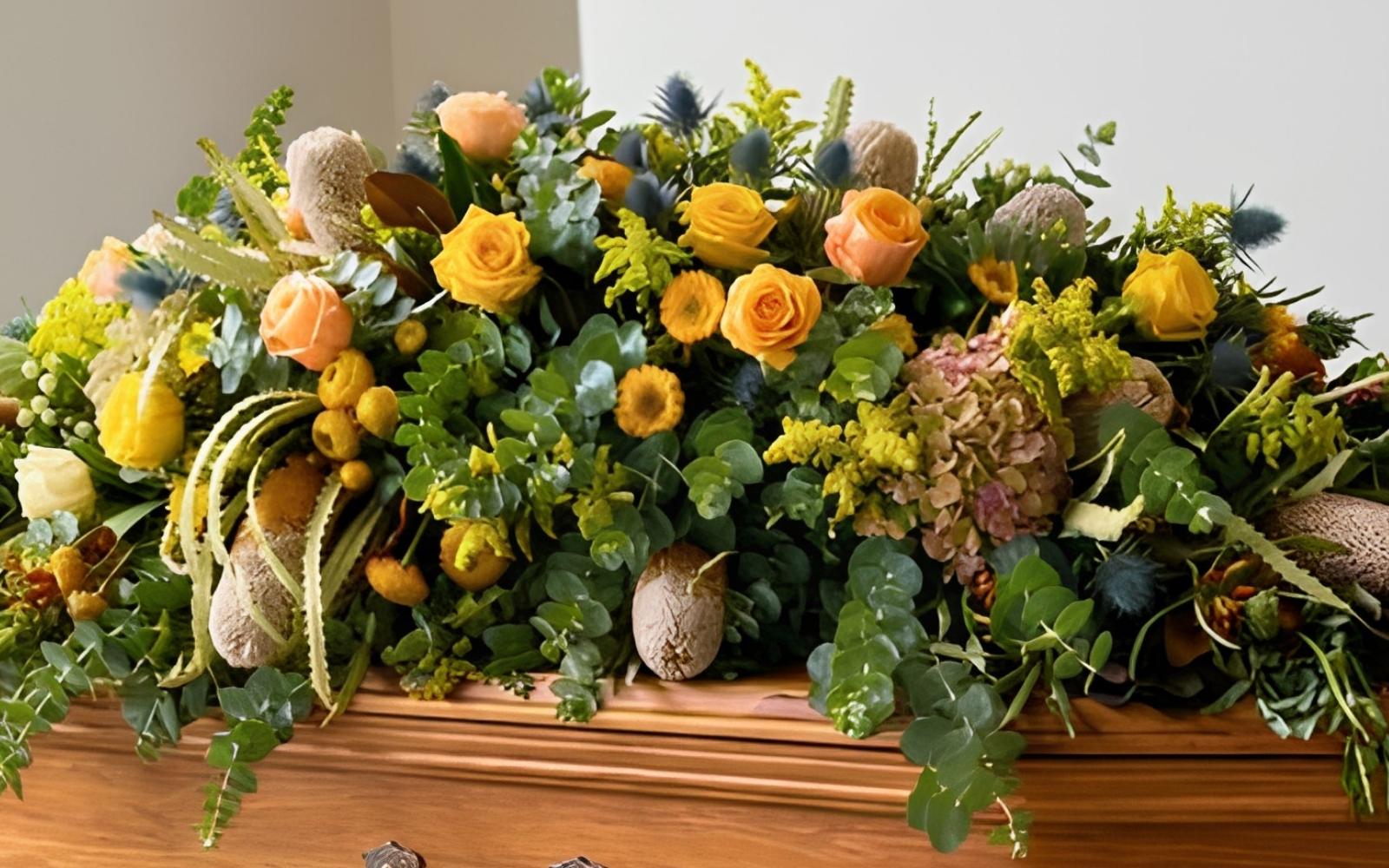 A native coffin spray in gold and green tones