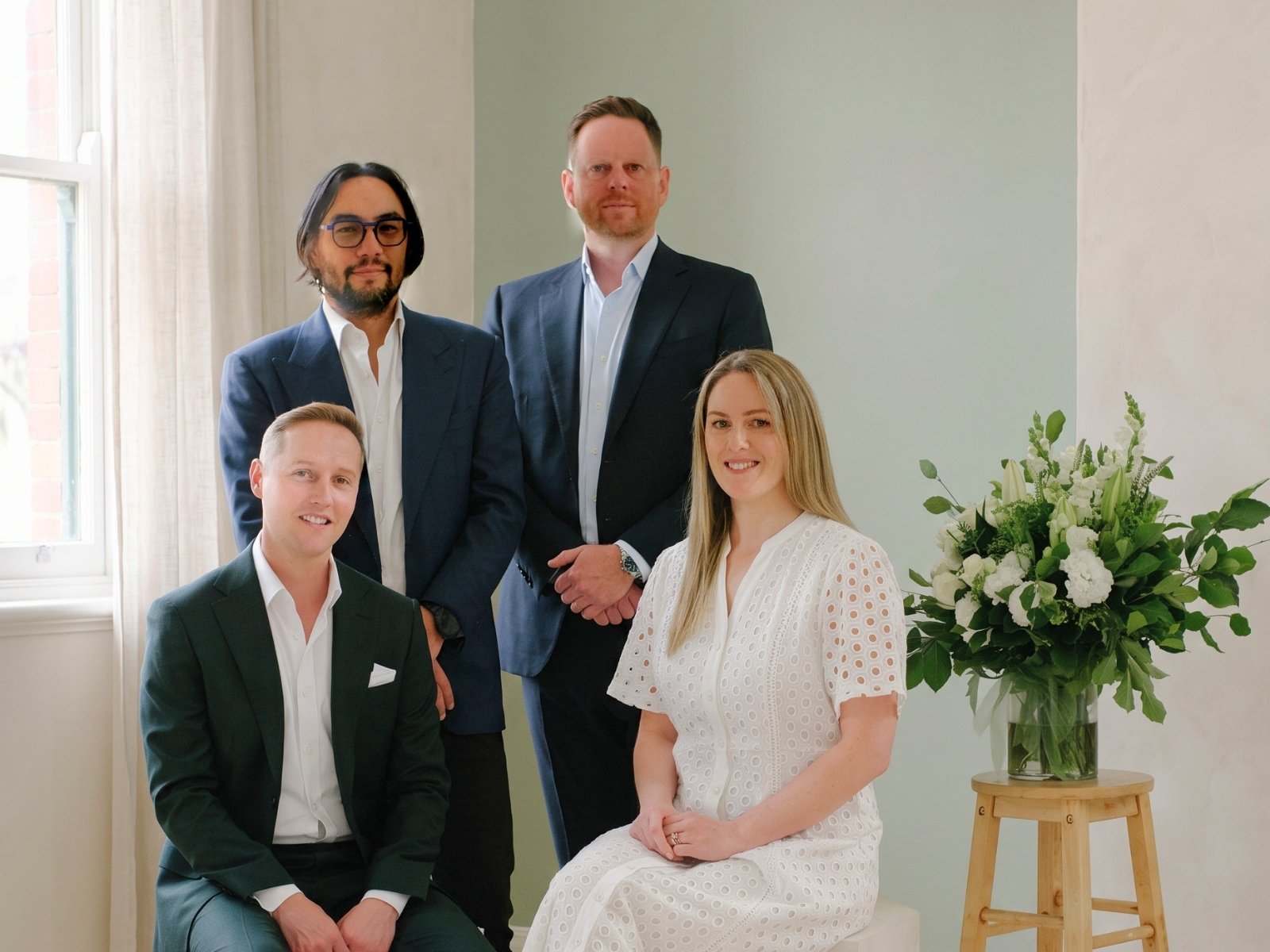 The four founders of Candour Funerals photographed together in a light-filled room