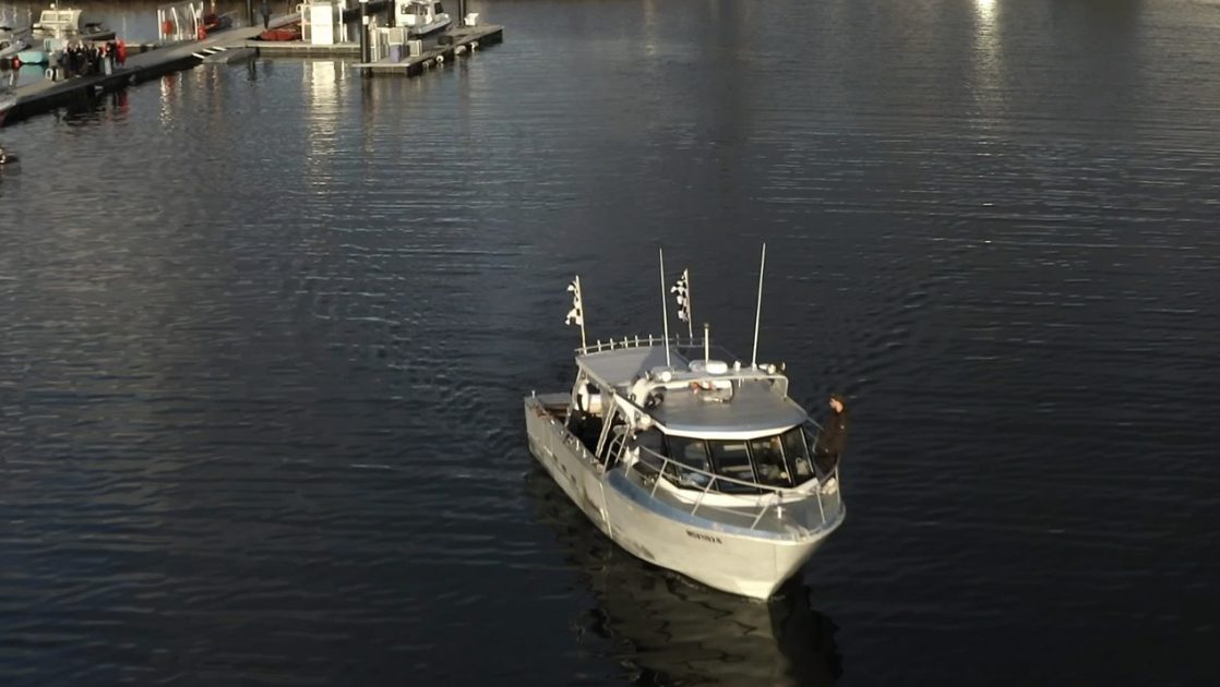 The charter vessel departing the marina for the sea burial