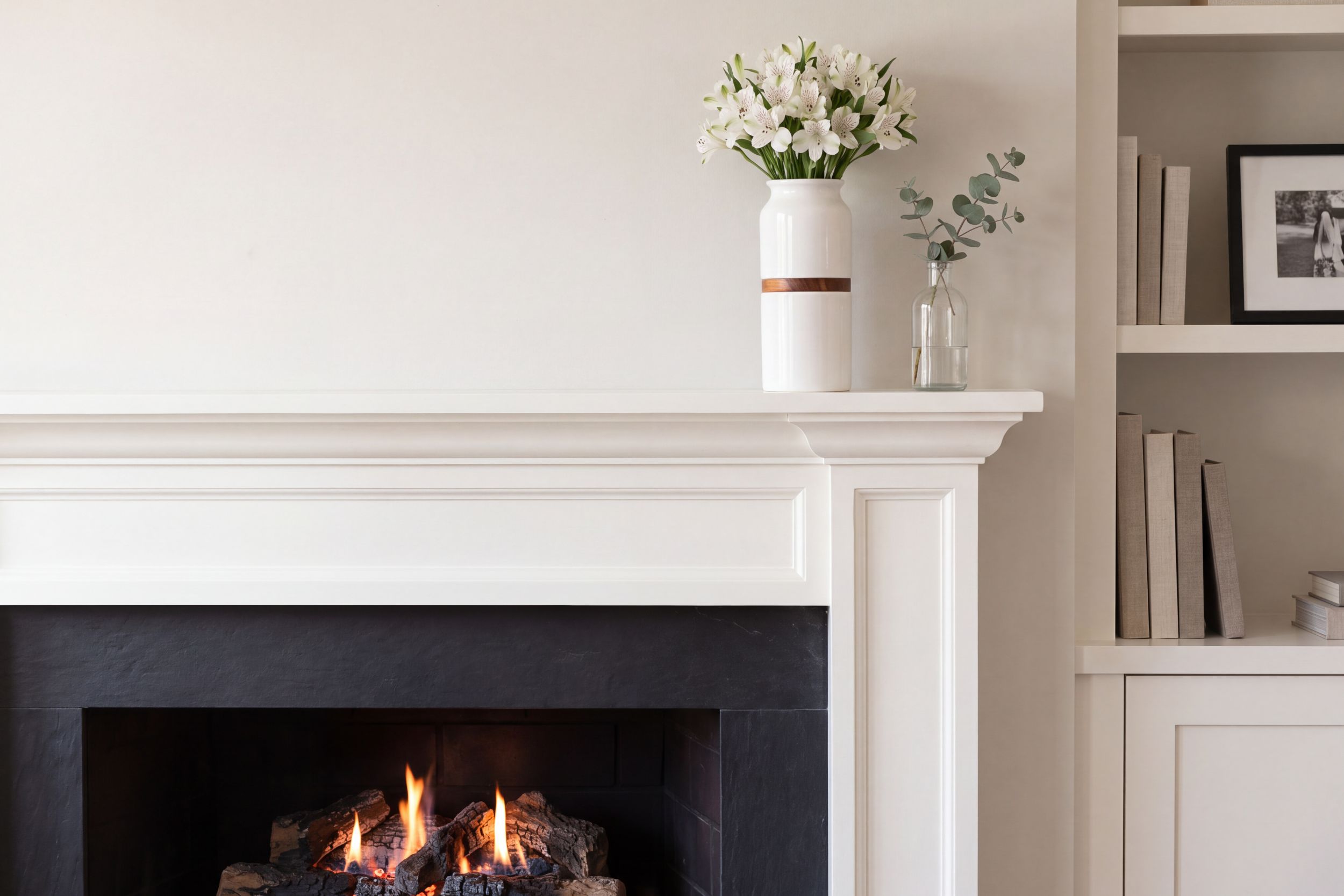 A white ceramic vase urn on the mantelpiece of a family home