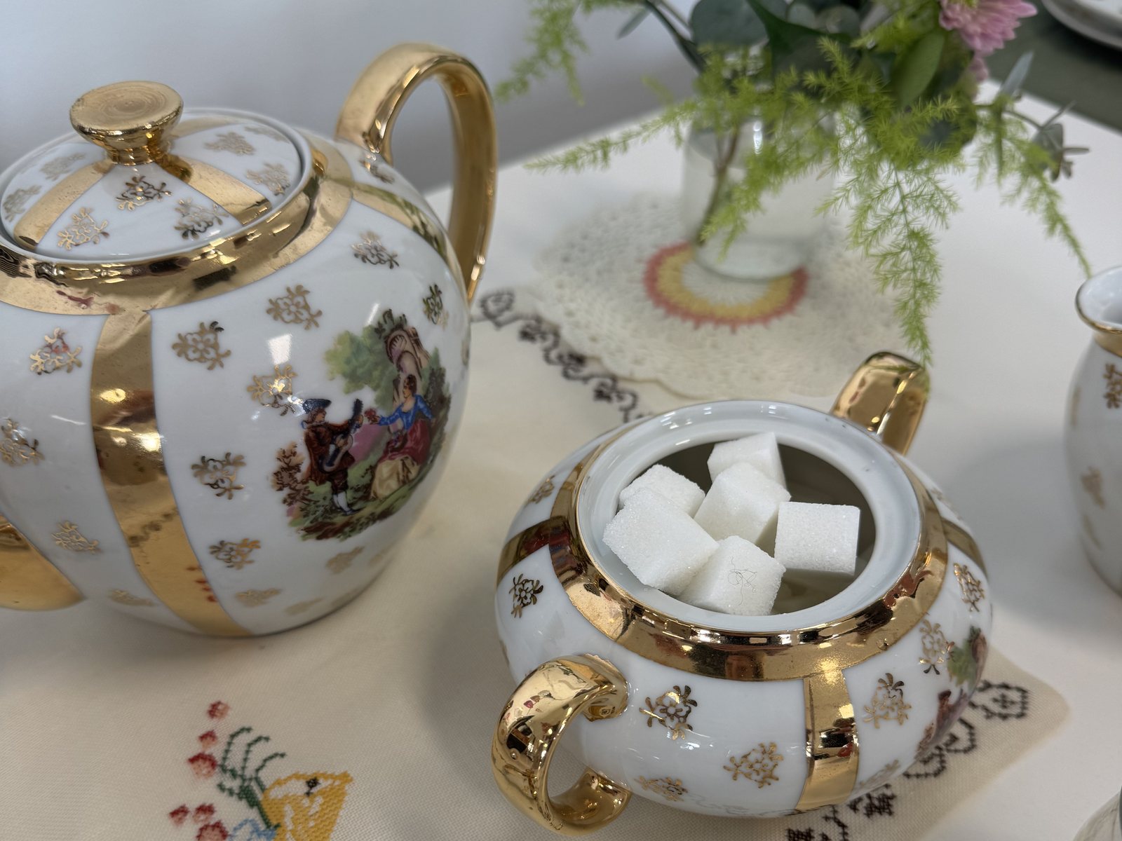 A vintage gold-trimmed teapot and sugar bowl set out for morning tea at Candour Connects