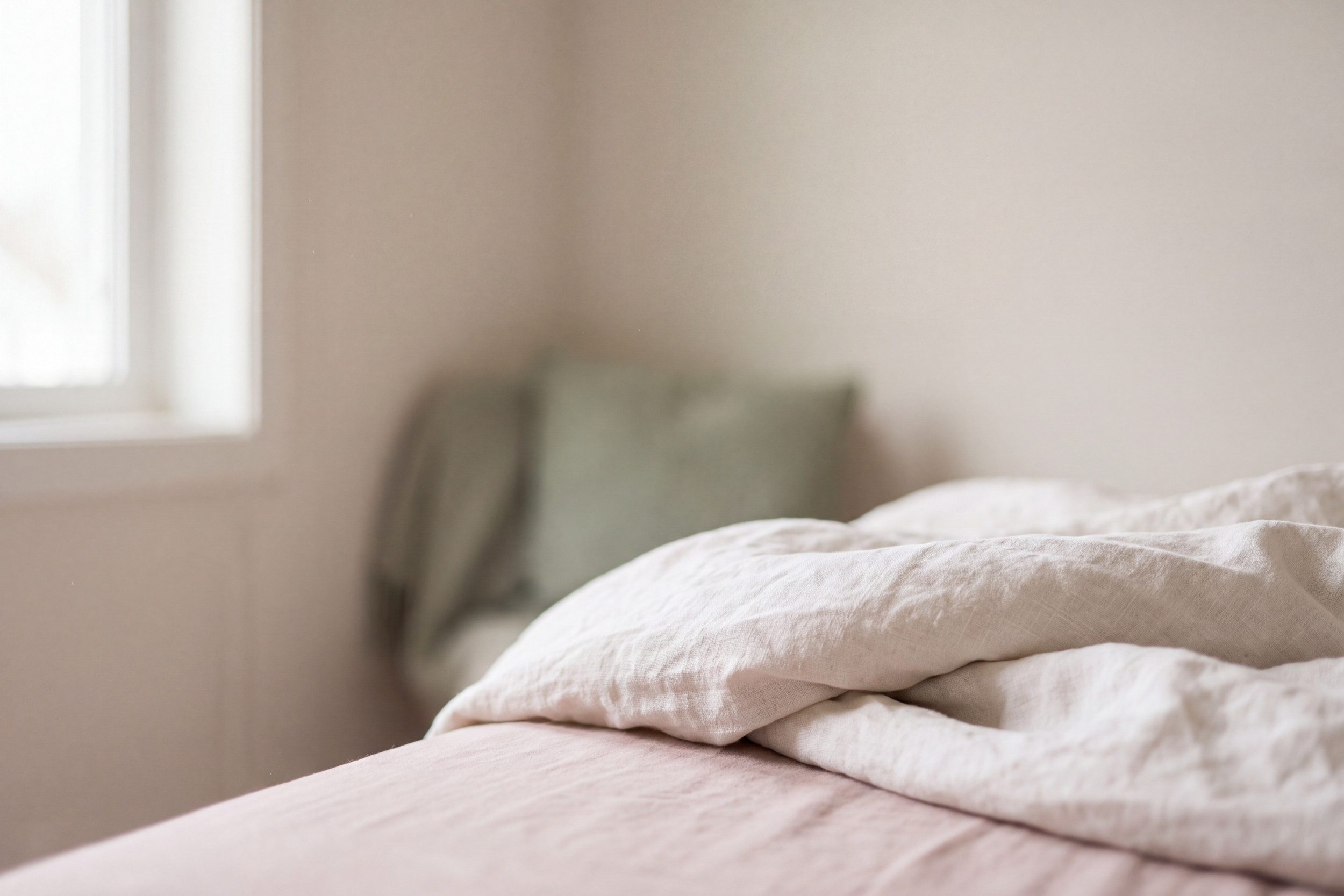 Morning light falling across soft linen in a quiet room