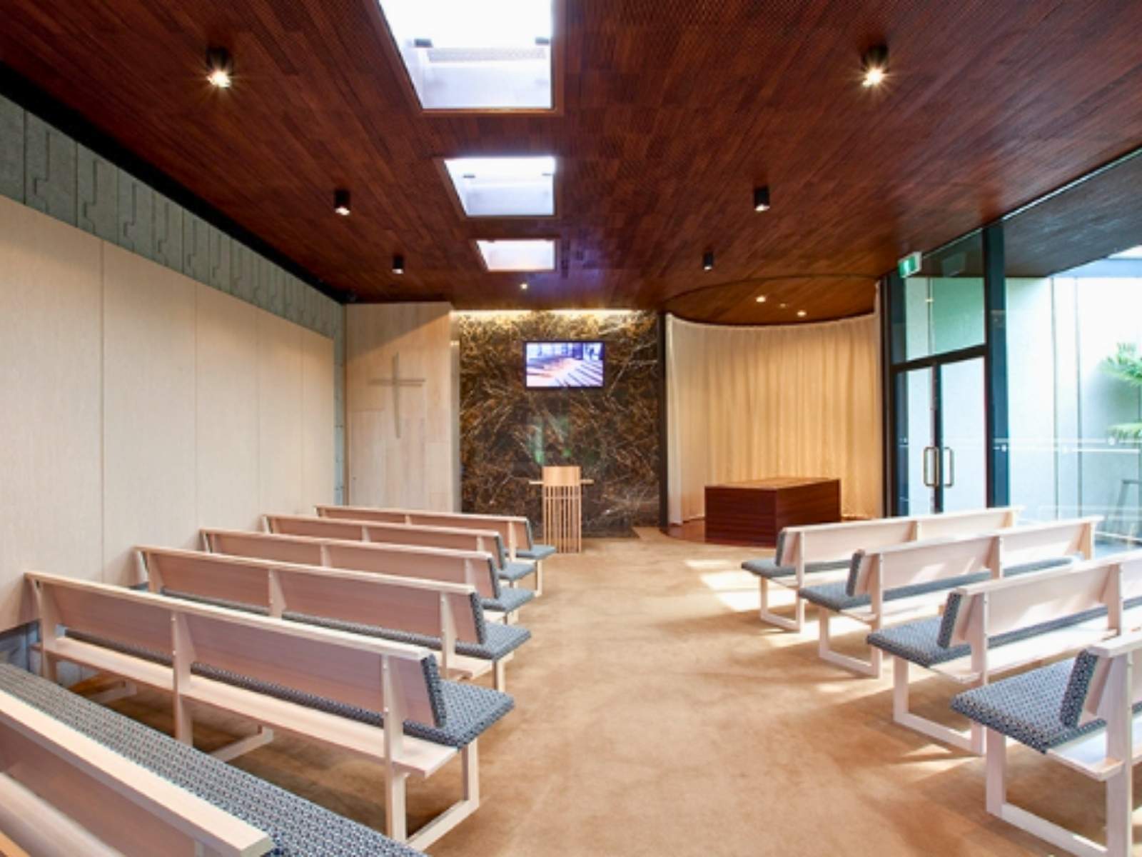Empty pews inside Wilson Chapel at Springvale Botanical Cemetery