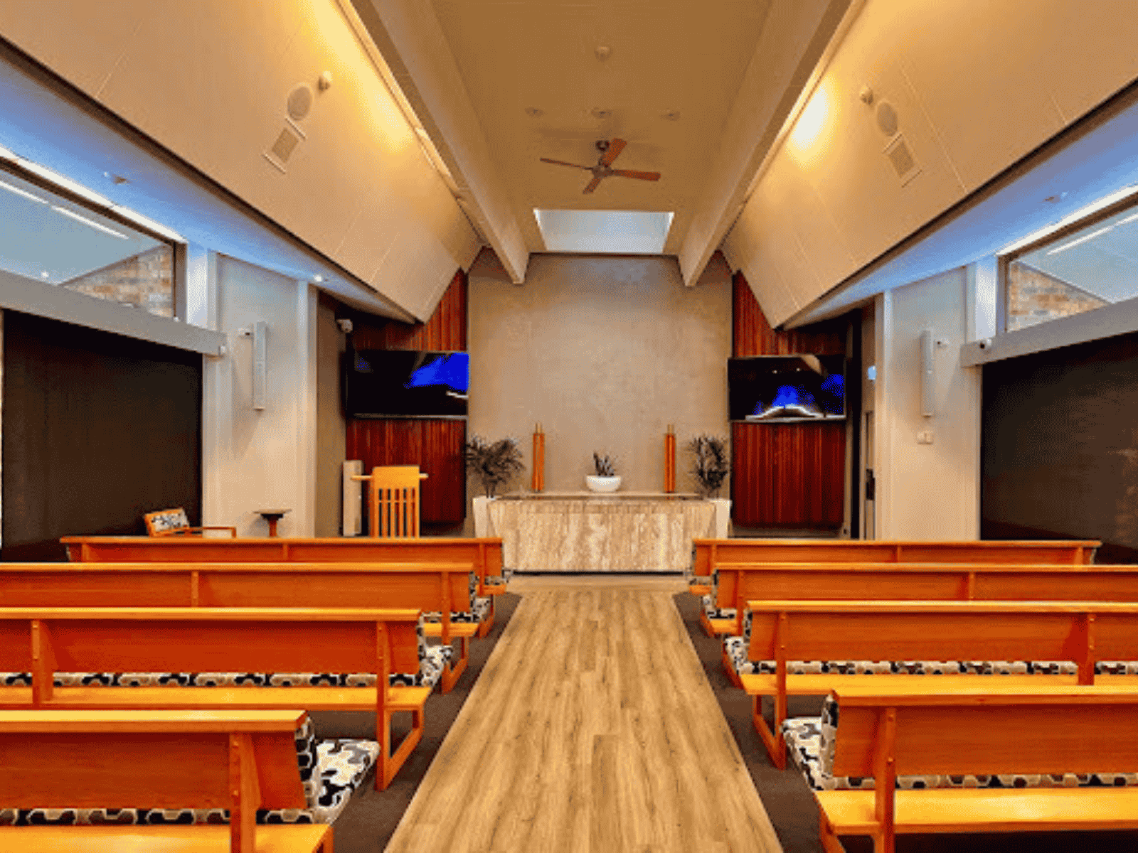 Inside The Crick Chapel at Fawkner Memorial Park. Shows empty seats looking to the front of the chapel.