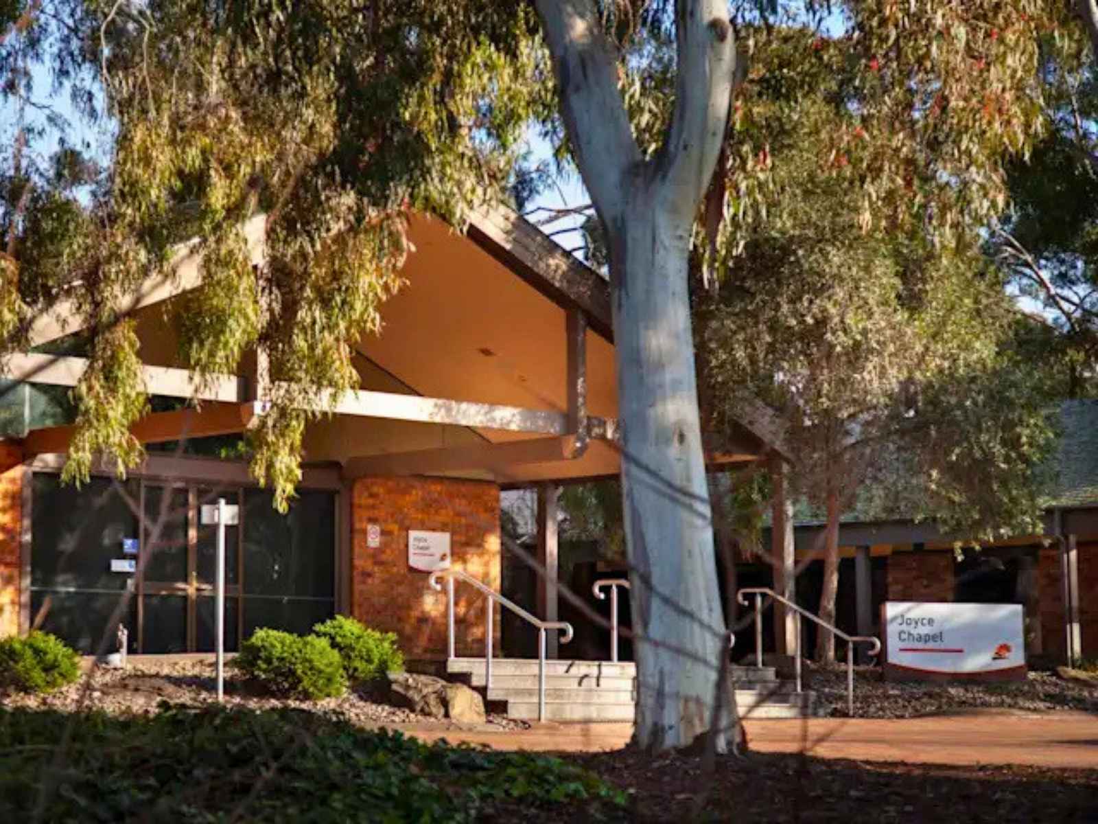 Outside the joyce chapel at Fawkner memorial park. Shows large trees at entrance providing shade.
