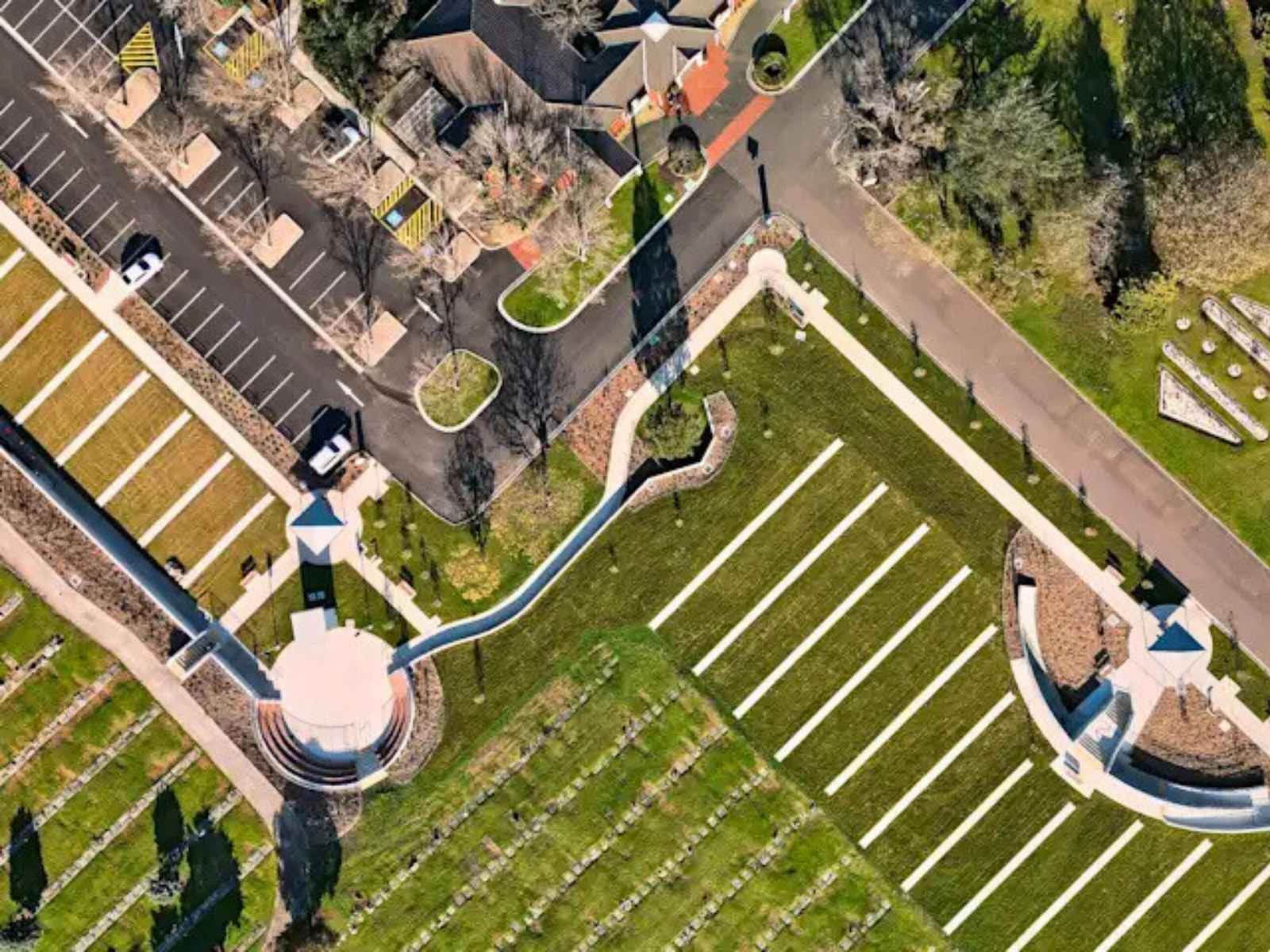 Aerial shot of grass, buildings and some monuments at Altona Memorial Park