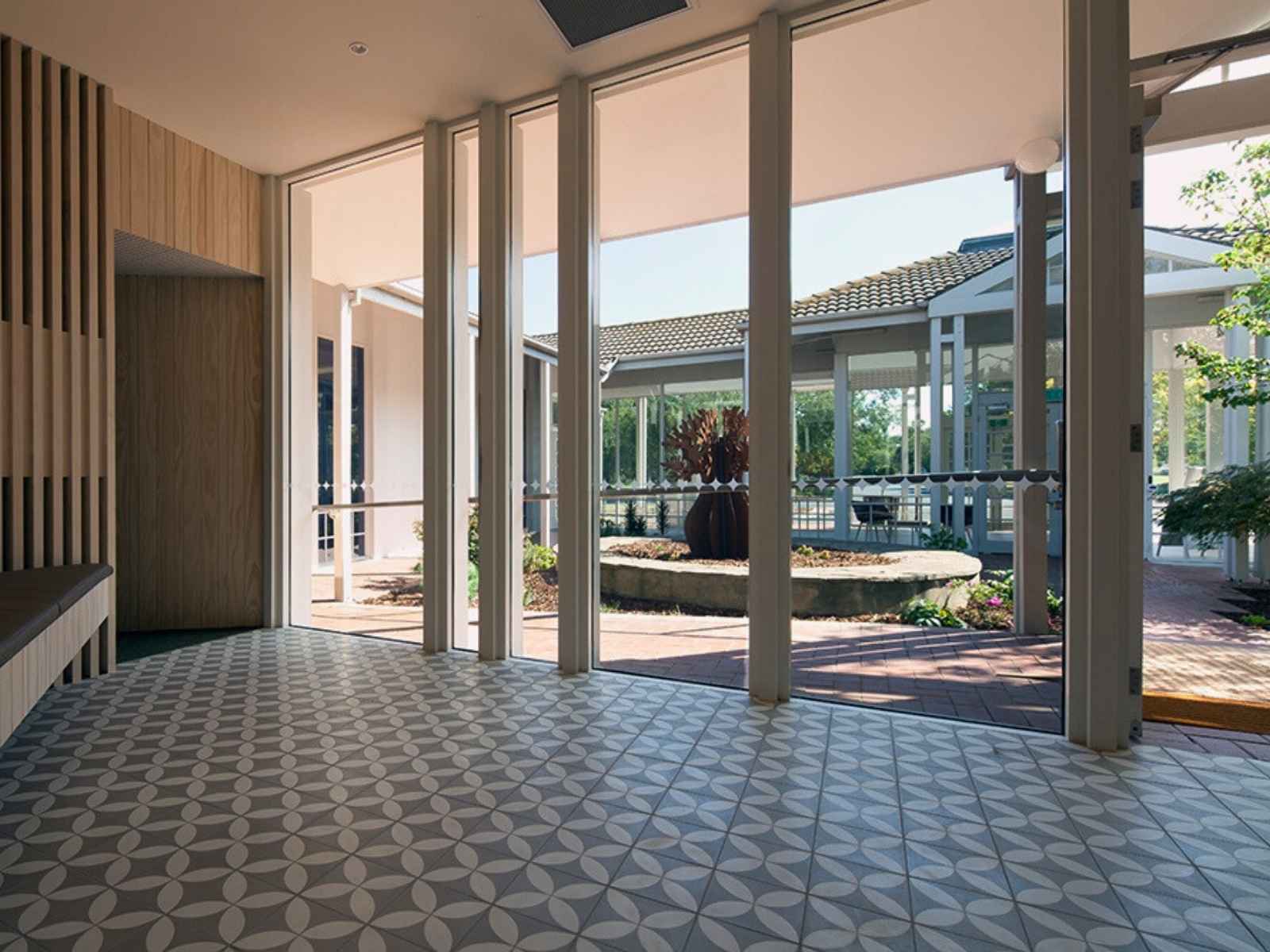 Chapel of Repose at Altona Memorial Park - entrance showing floor to ceiling windows and tiled floor