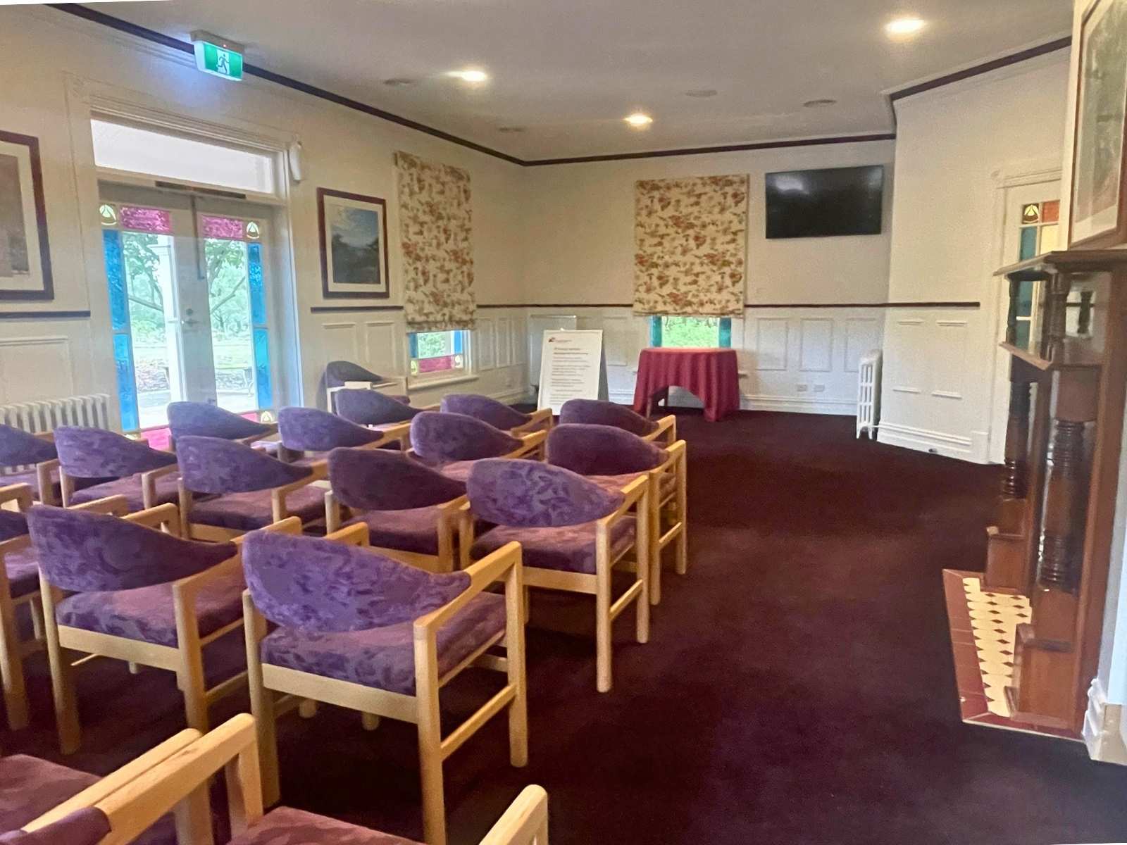 Inside Federation Chapel at Lilydale Memorial Park. Purple empty chairs.