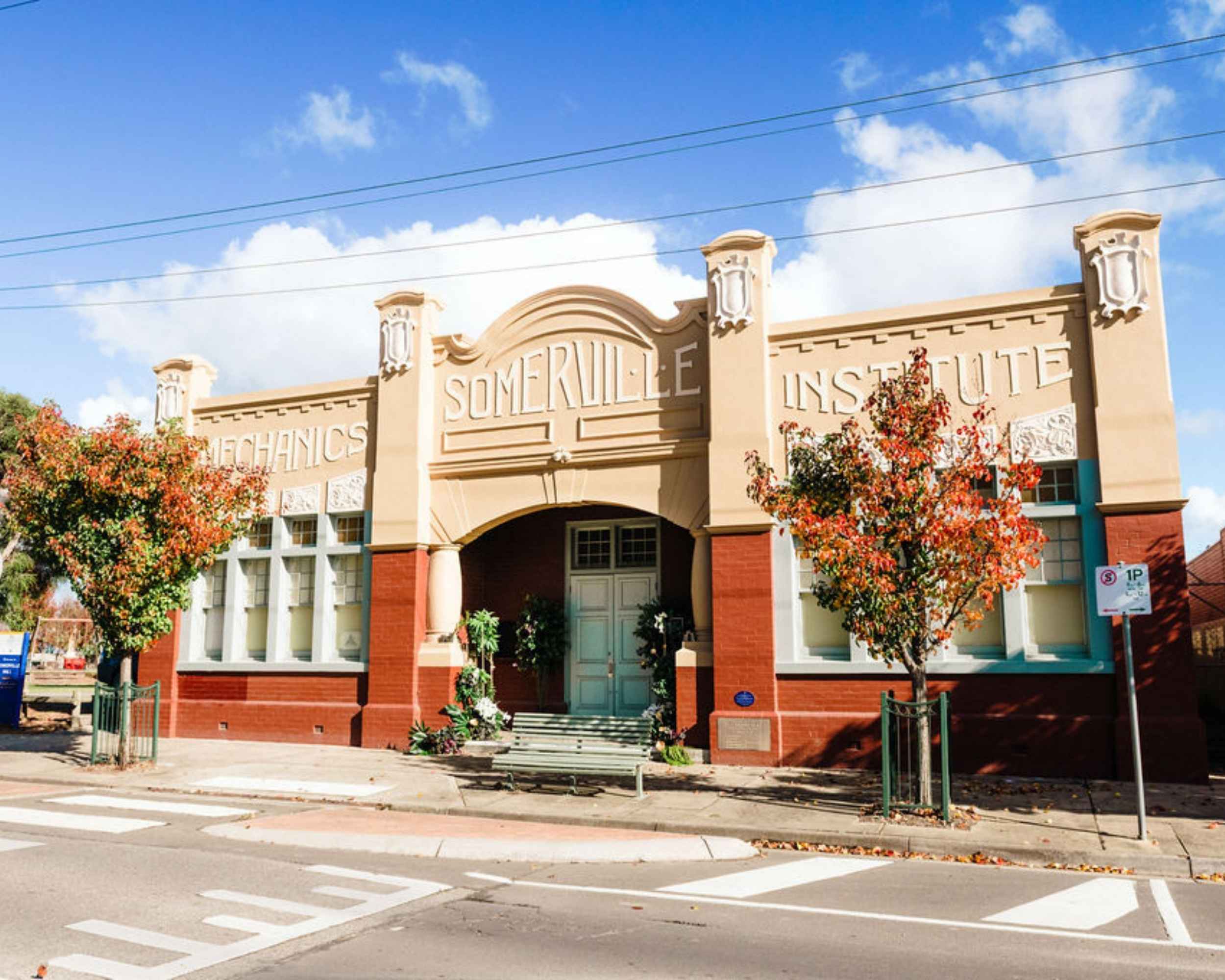 Front view of Somerville Mechanics Institute building with heritage architecture and autumn trees.