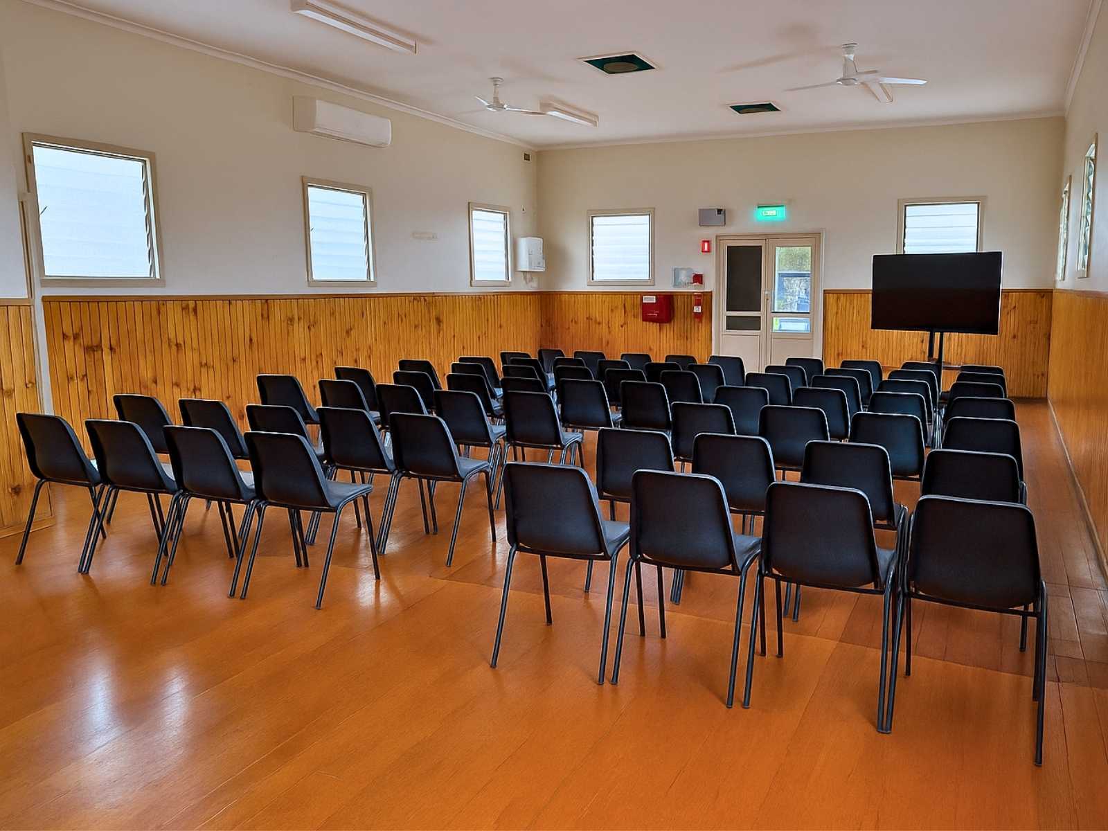 Alternate angle of the Bittern Hall interior, showing seating arrangement, timber flooring, and ample natural light.