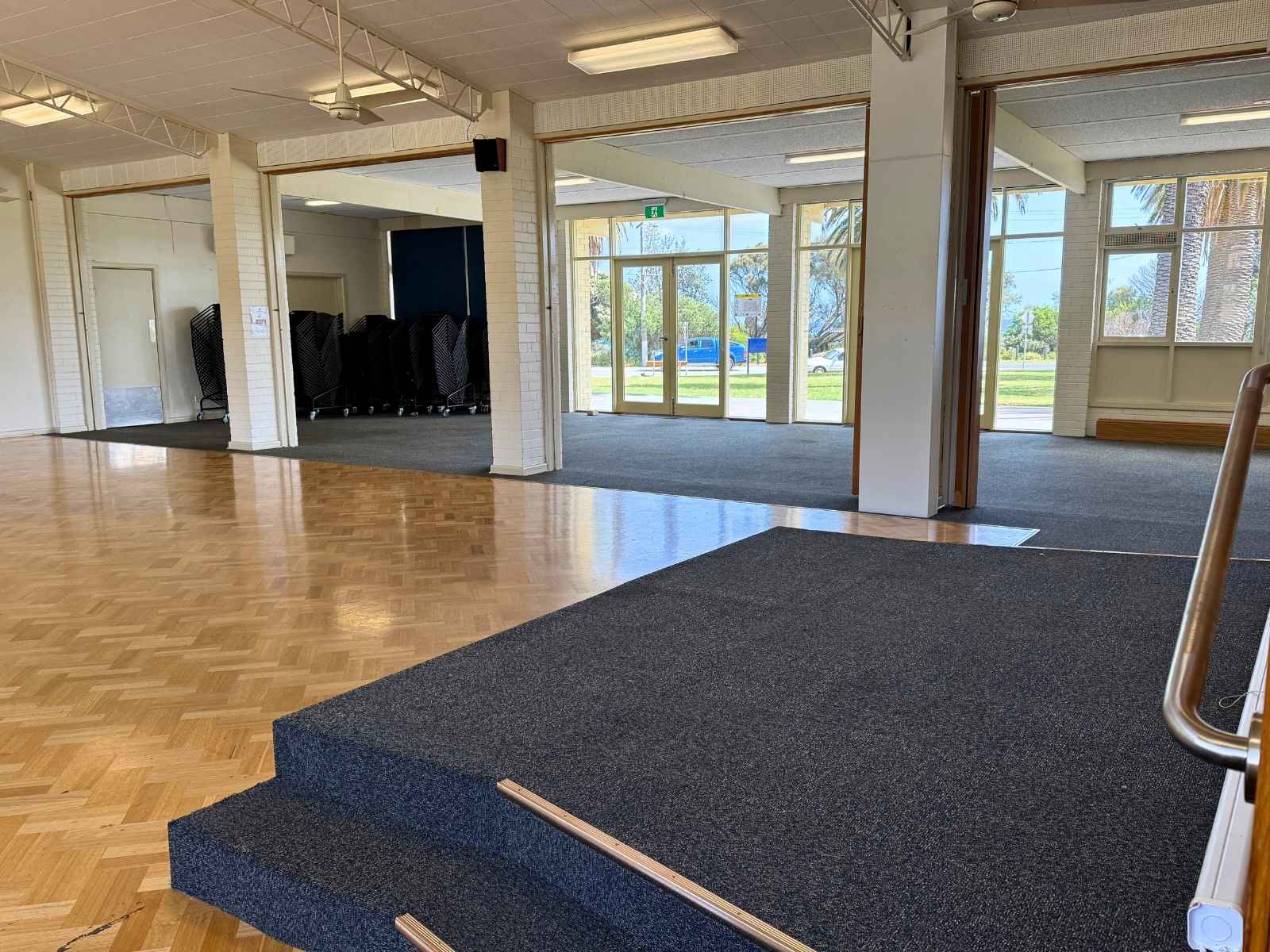 Shows the accessible interior with open partition doors and a carpeted platform ramp.