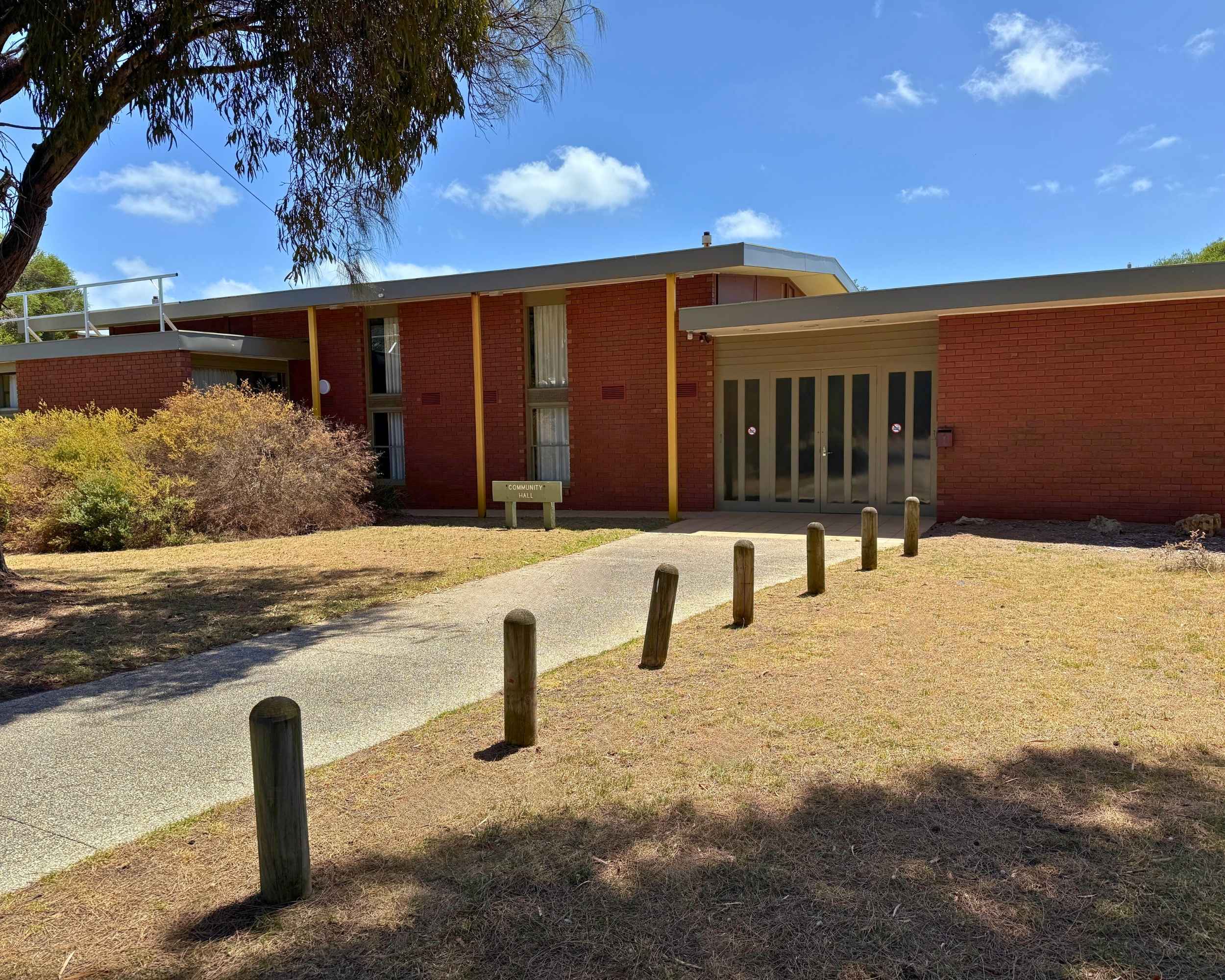 Front entrance of Blairgowrie Community Hall with red brick exterior and surrounding trees.