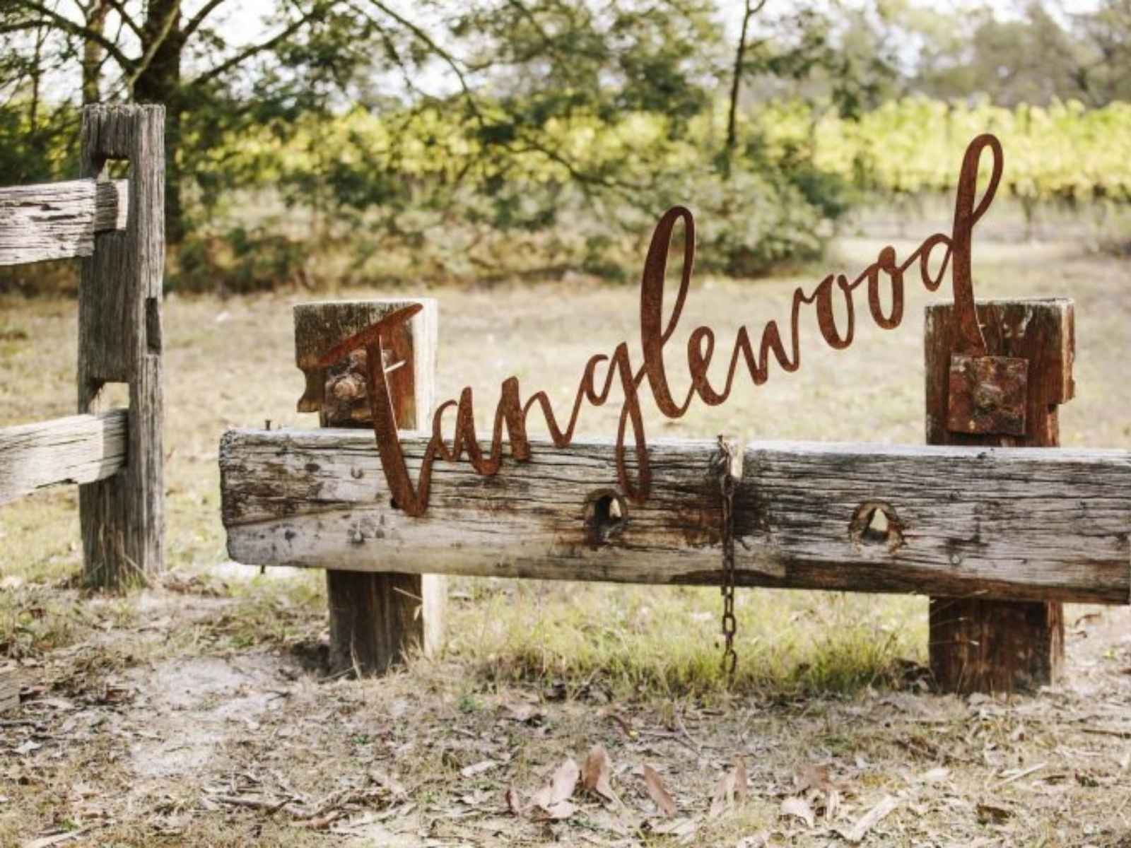 Tanglewood sign in wrought iron cursive writing at the entrance to the estate.