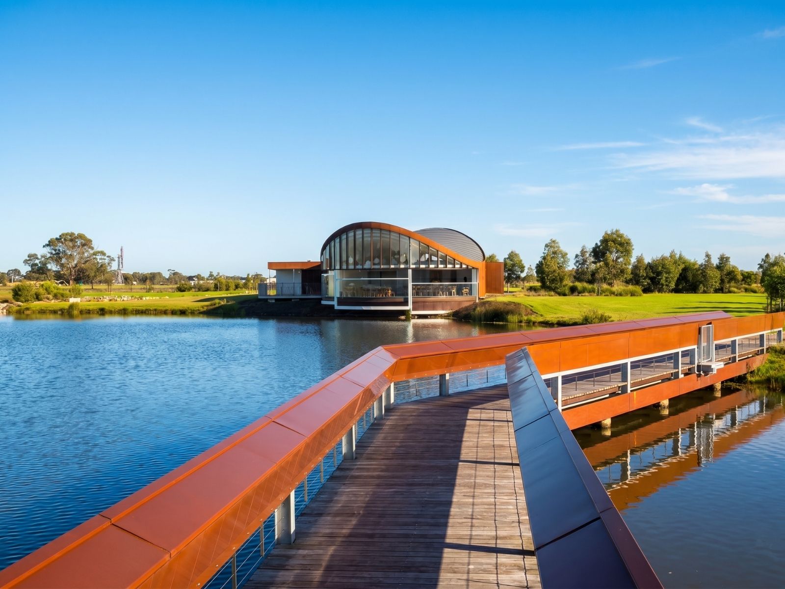 Timber boardwalk bridge with Corten steel balustrades leading to Sanctuary Chapel at Bunurong Memorial Park
